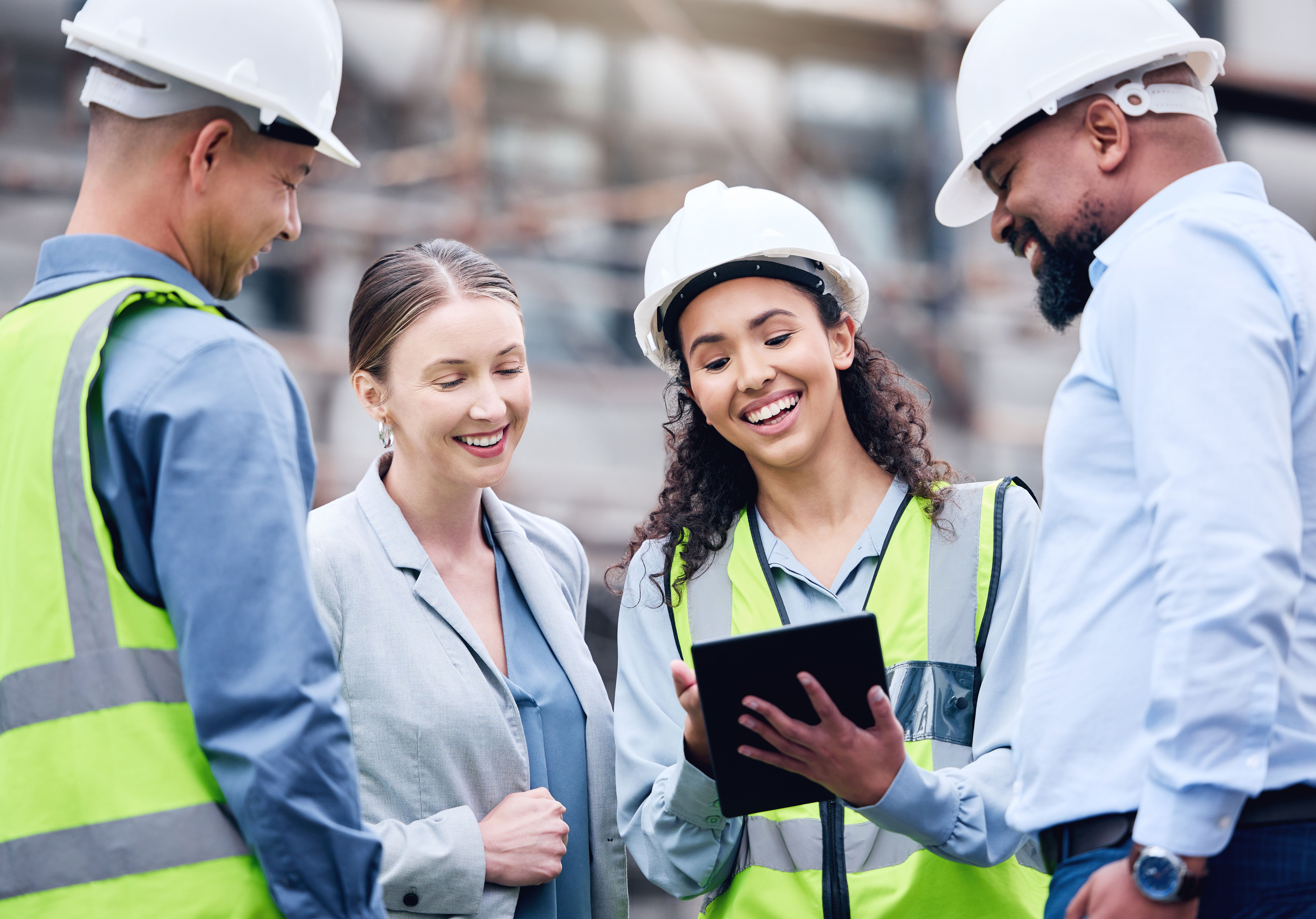 Shot of a group of architects using a digital tablet at a building site
