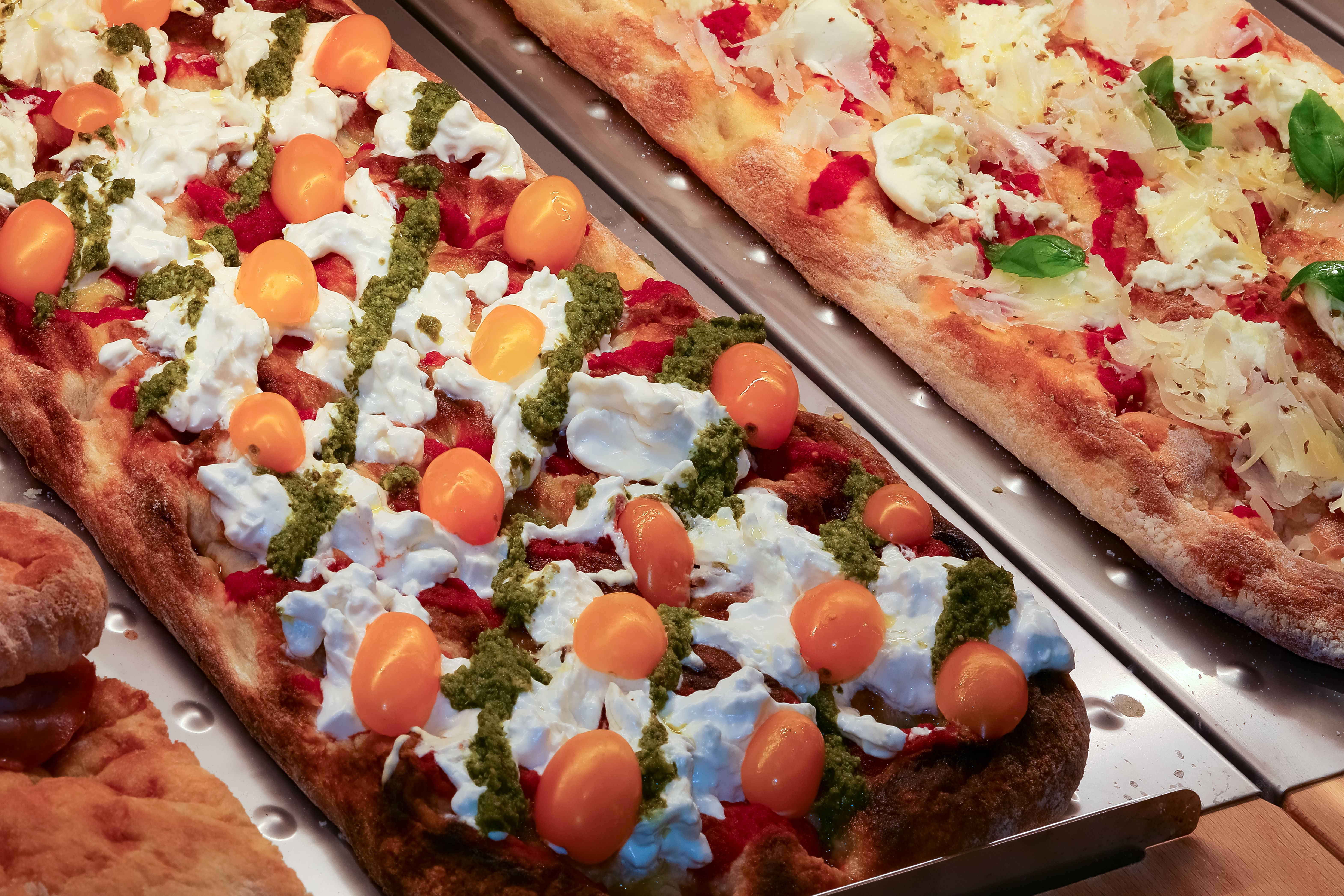 focaccia baked in a wood oven with fresh tomato mozzarella cheese in the showcase