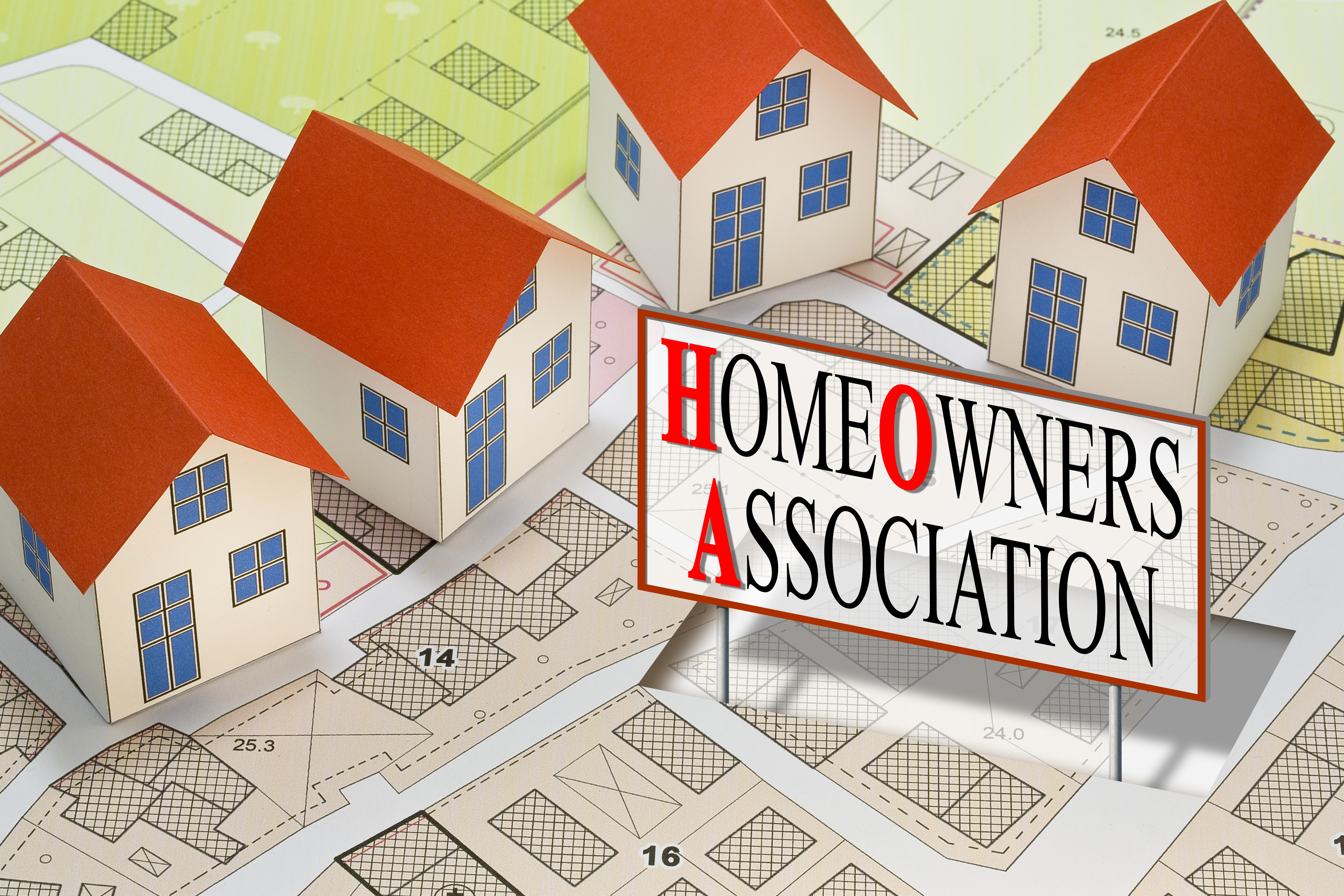 Homeowner Association concept with residential homes models against an imaginary city map and text Homeowner Association concept with residential homes models against an imaginary city map and text