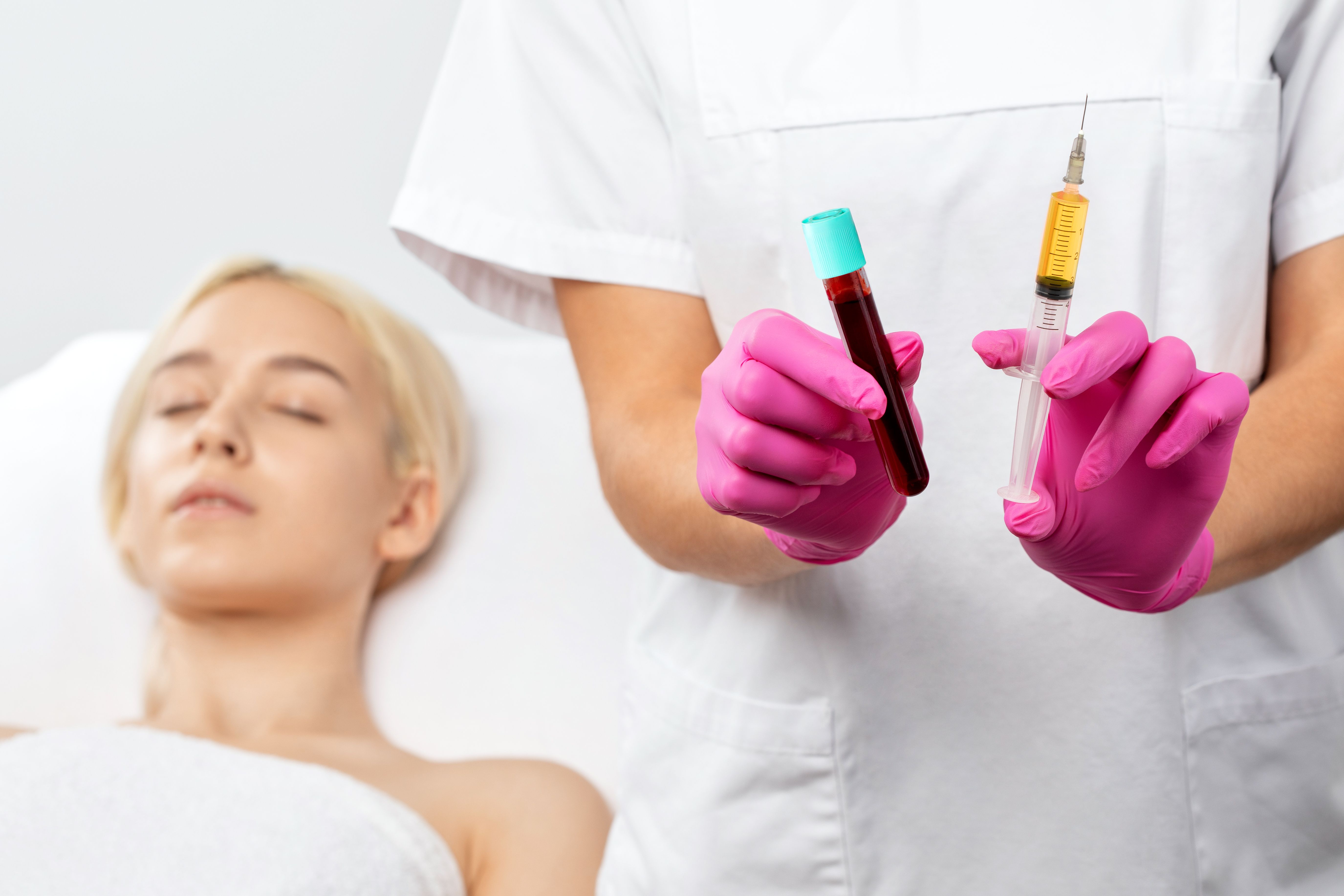 Beautician will do PRP therapy for the face against wrinkles. She has blood plasma for injections and a syringe with plasma in her test tube. Cosmetology in the beauty salon.