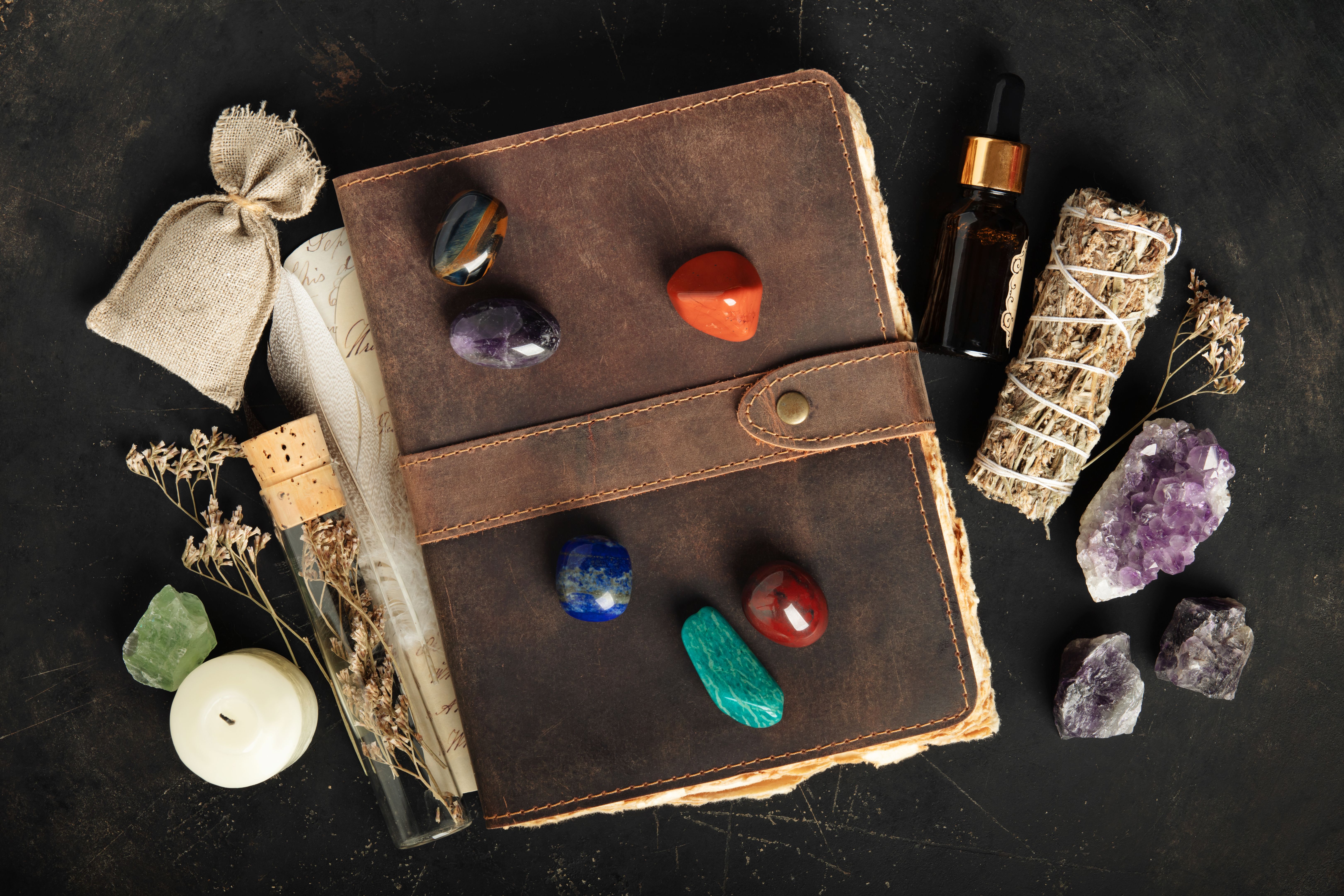 Rustic Leather Journal with Healing Crystals on Dark Background