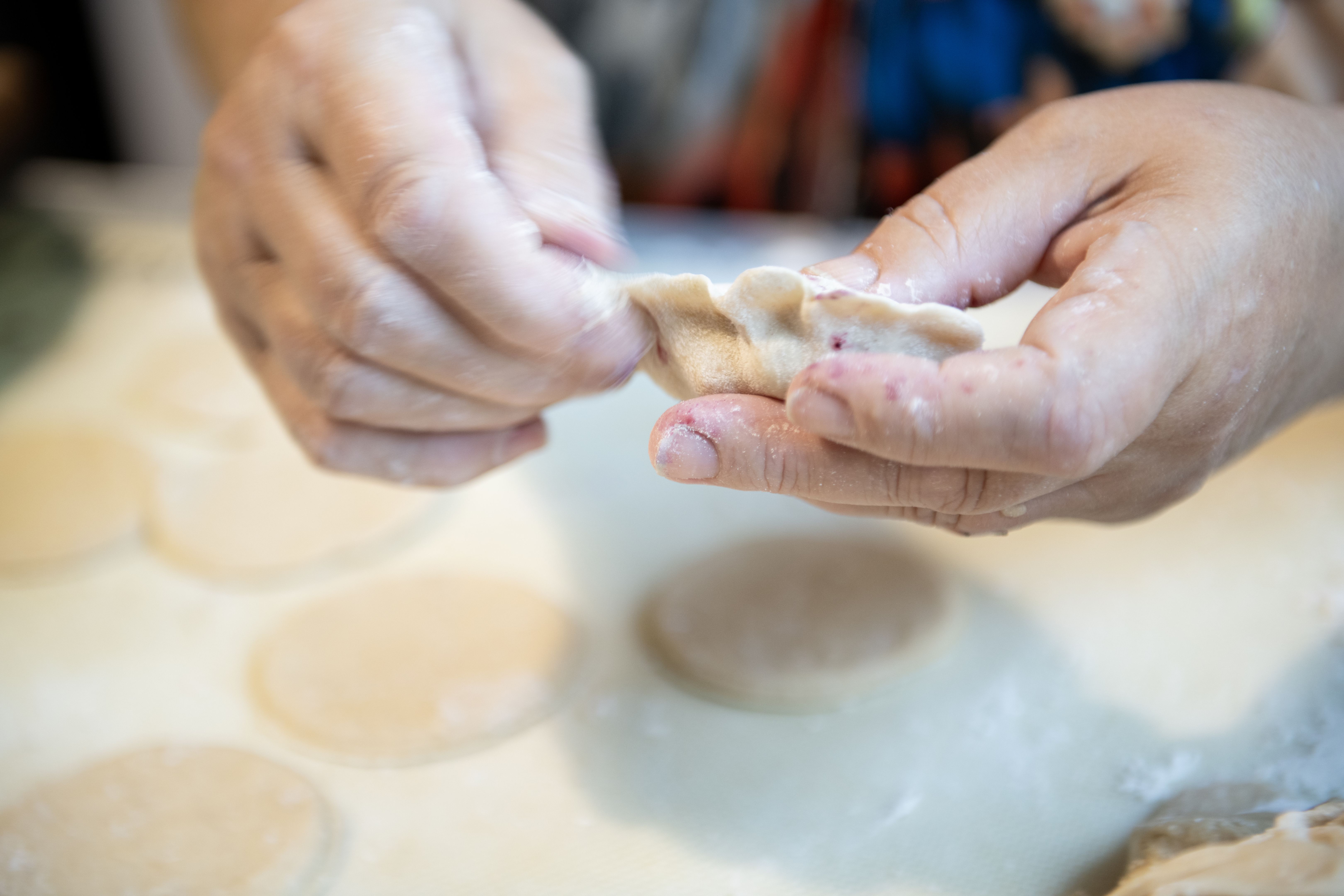 hand folding dumplings