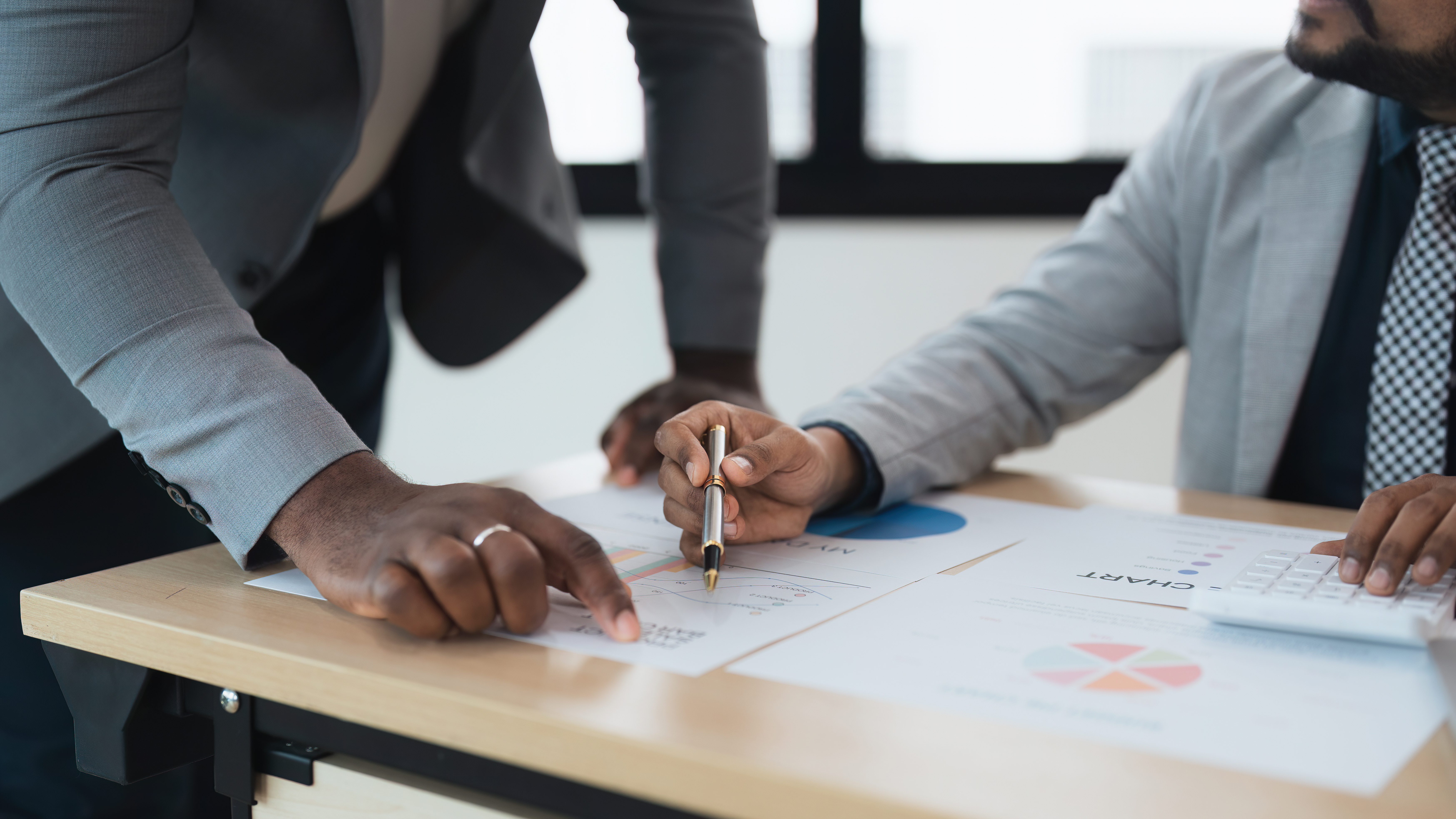 Business people indian and african american worker looking discussing corporate strategy in teamwork, working on computer laptop in office at office