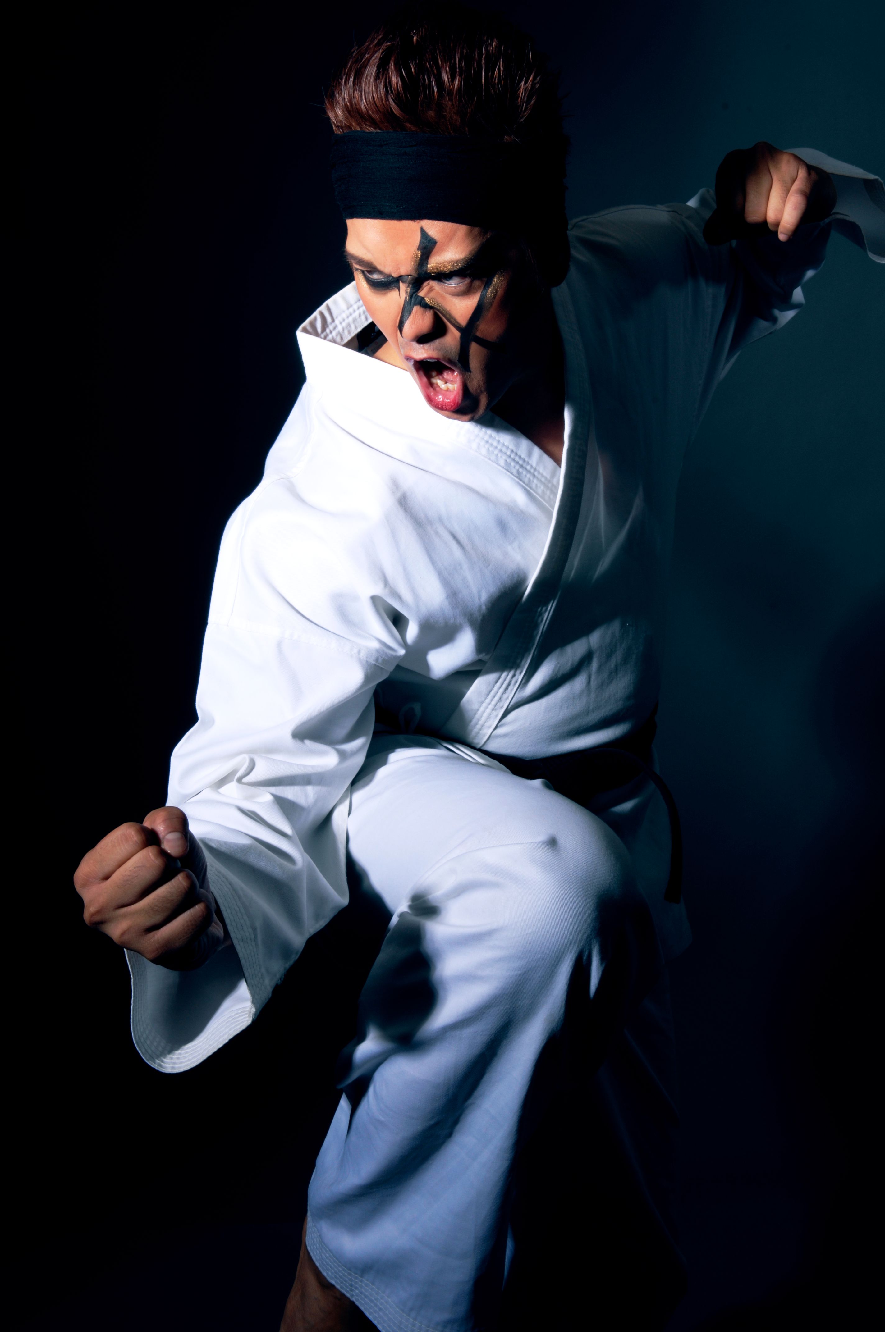 Man Wearing Karate Gi and Face Paint Posing