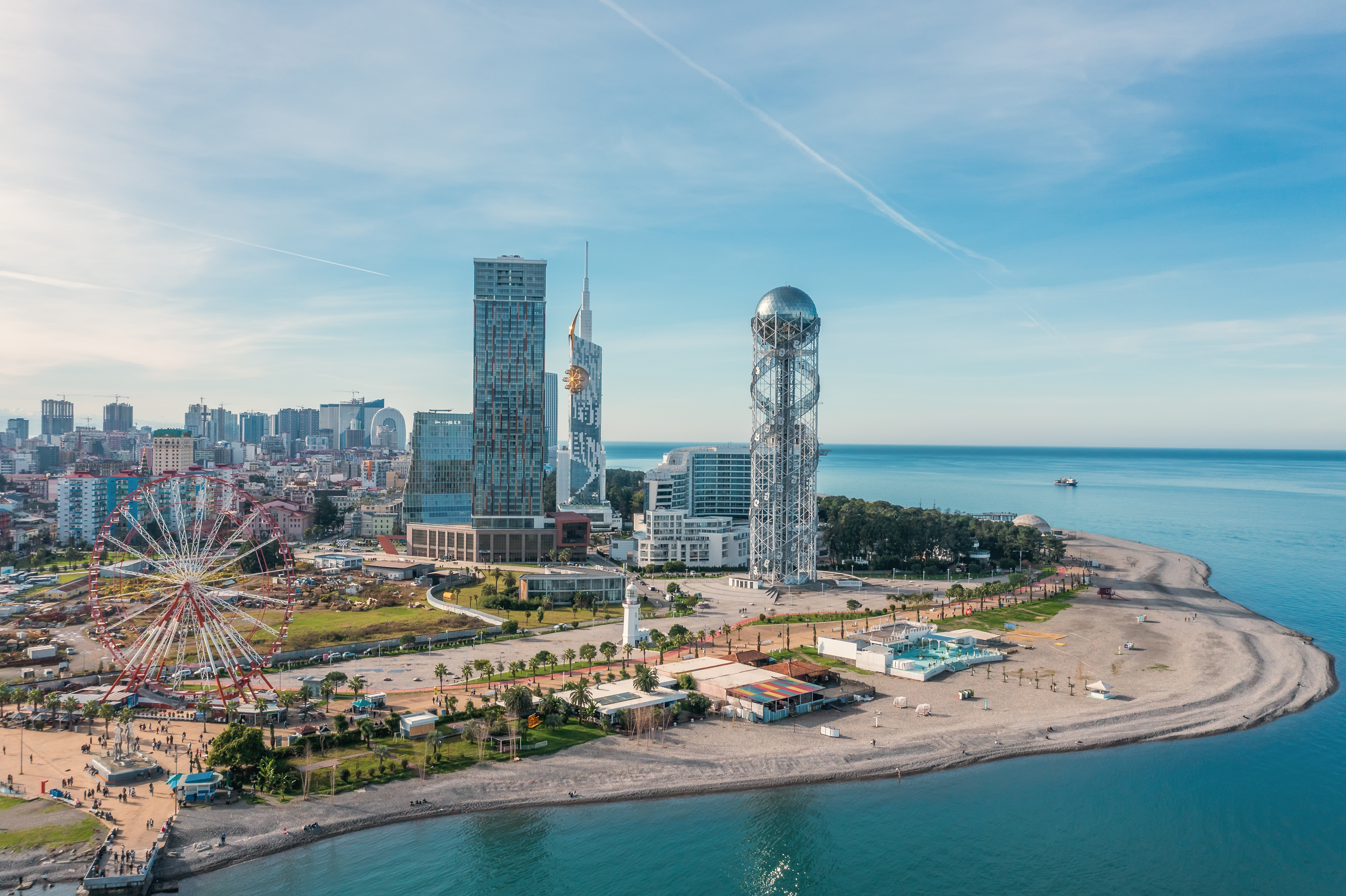 Drone photo of Batumi, Georgian resort at Black Sea, aerial panoramic view of downtown with ferris wheel and modern skyscrapers