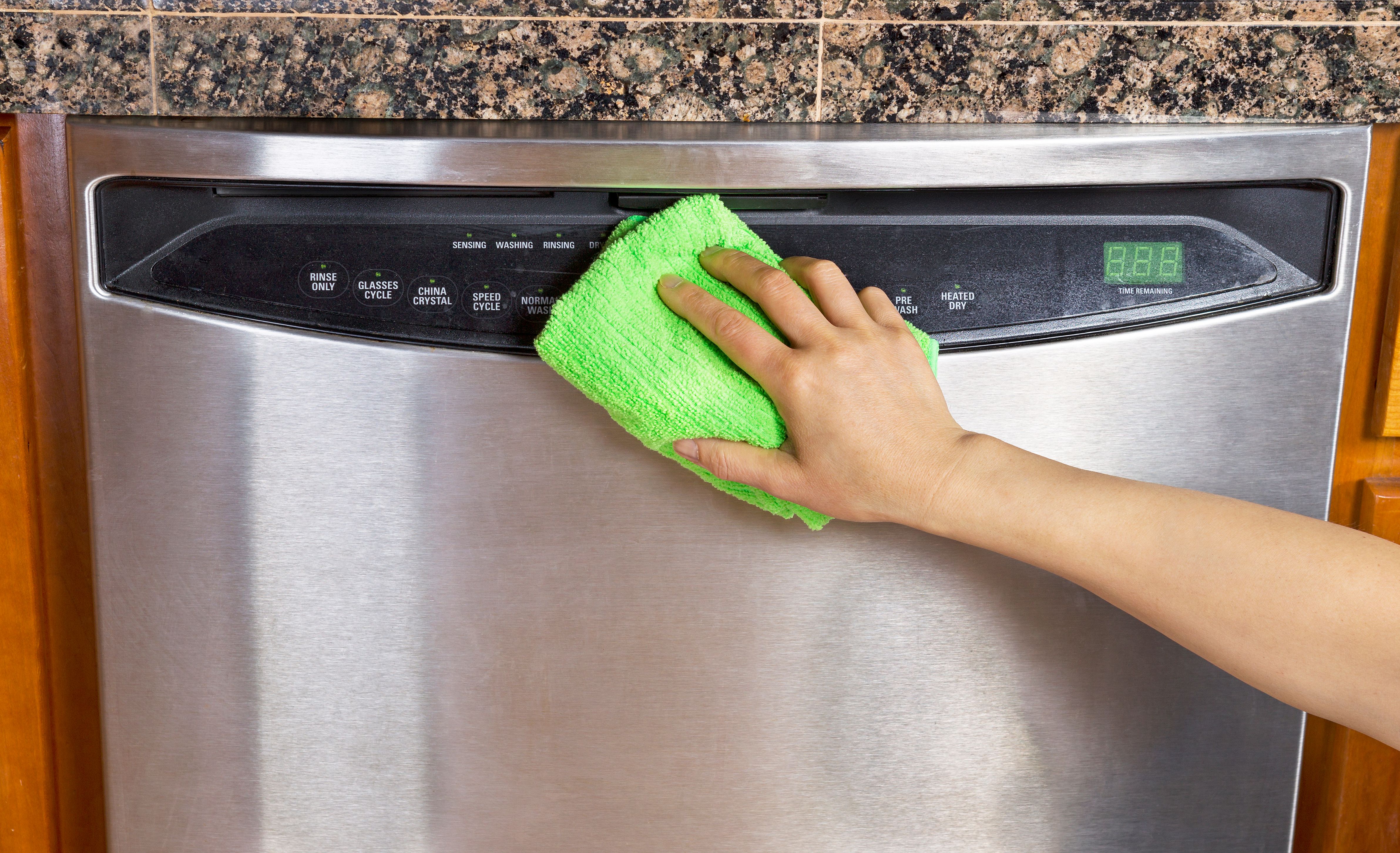 Wiping Clean Dishwasher with Microfiber rag