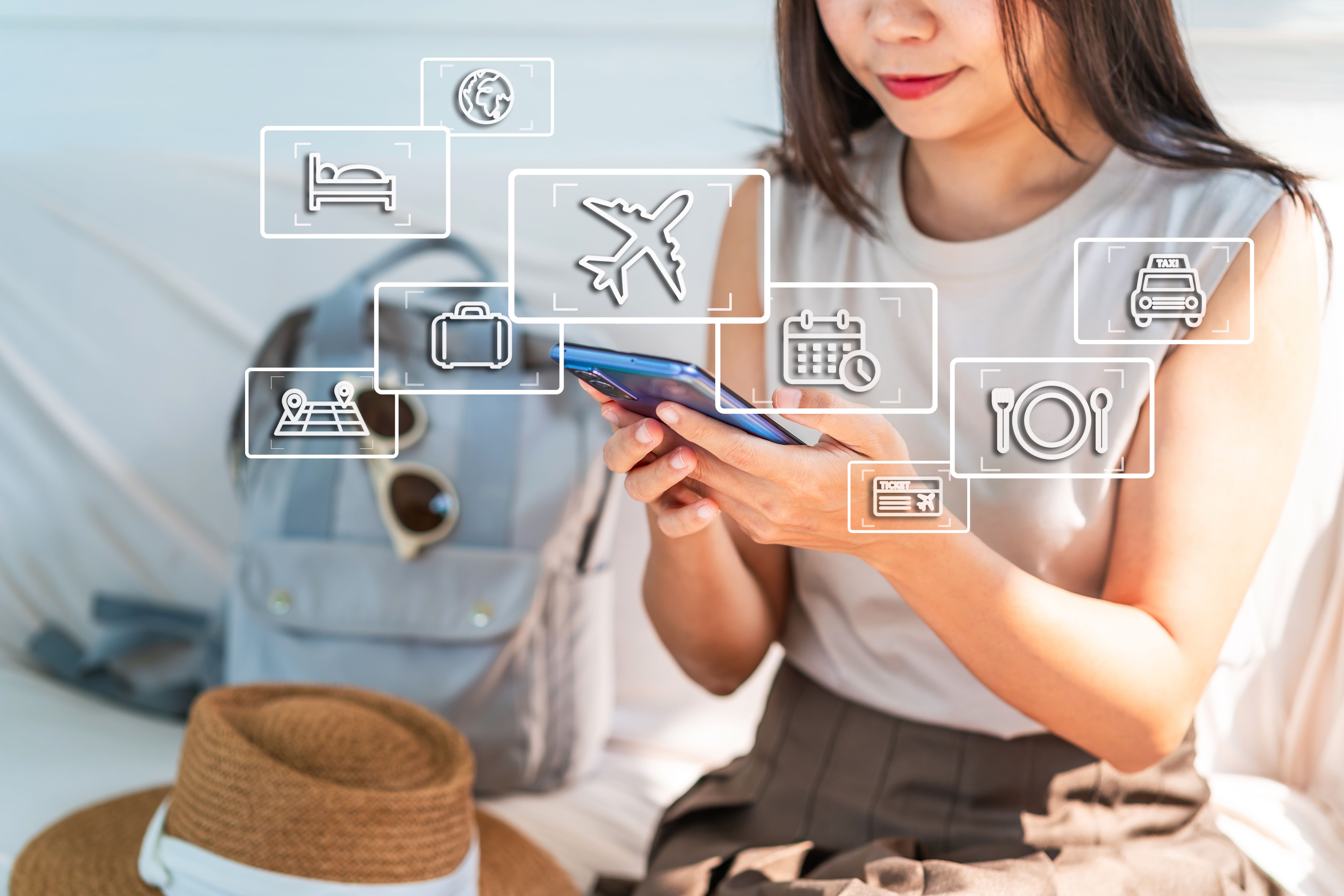 Young woman traveler using smartphone for planning a trip, flight booking and find travel information on summer vacation