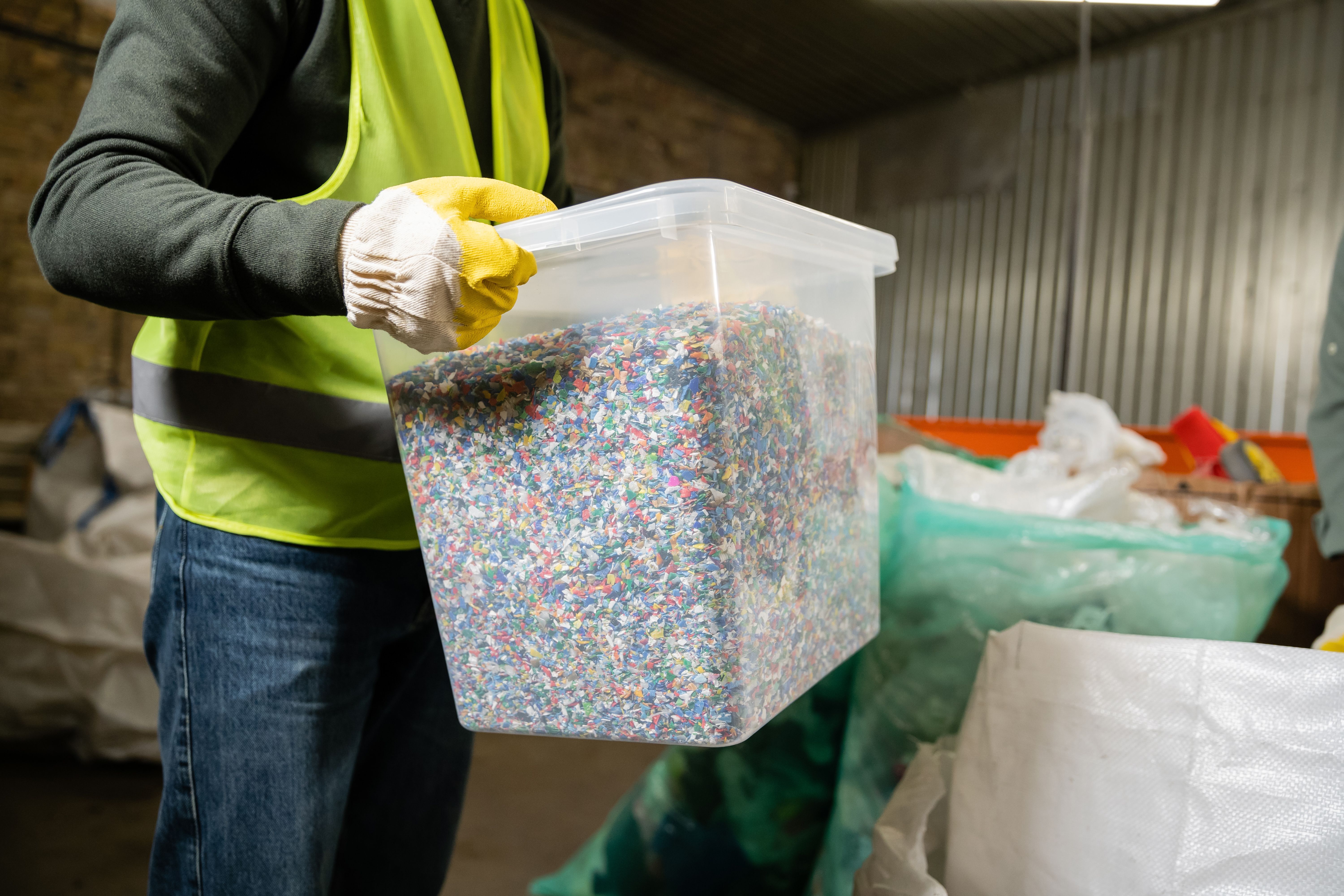 Volunteer sorting recyclables to promote sustainability in a community clean-up event