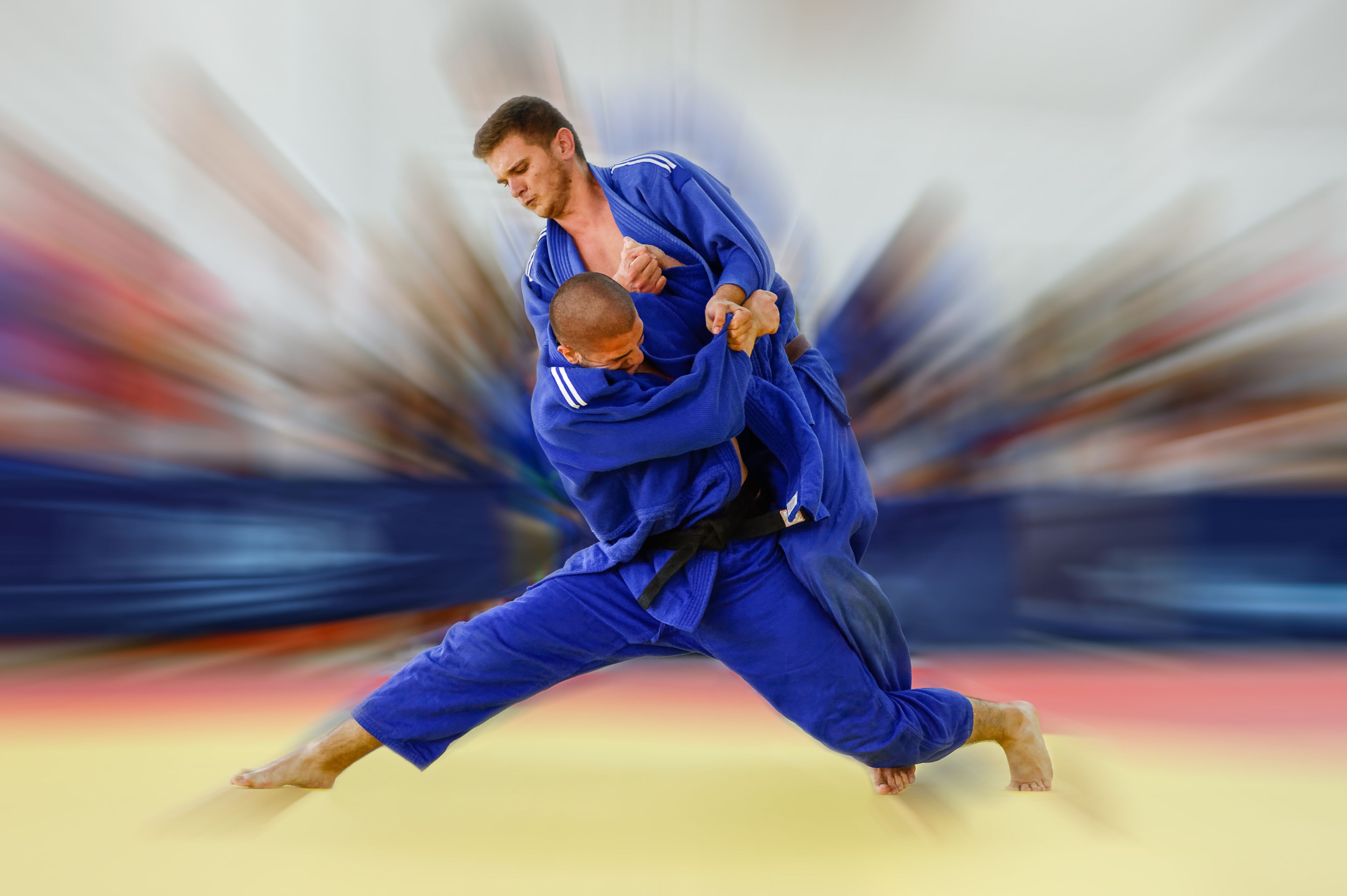 Judoka attempting Tai Otoshi throw with full commitment Judoka attempting Tai Otoshi throw with full commitment