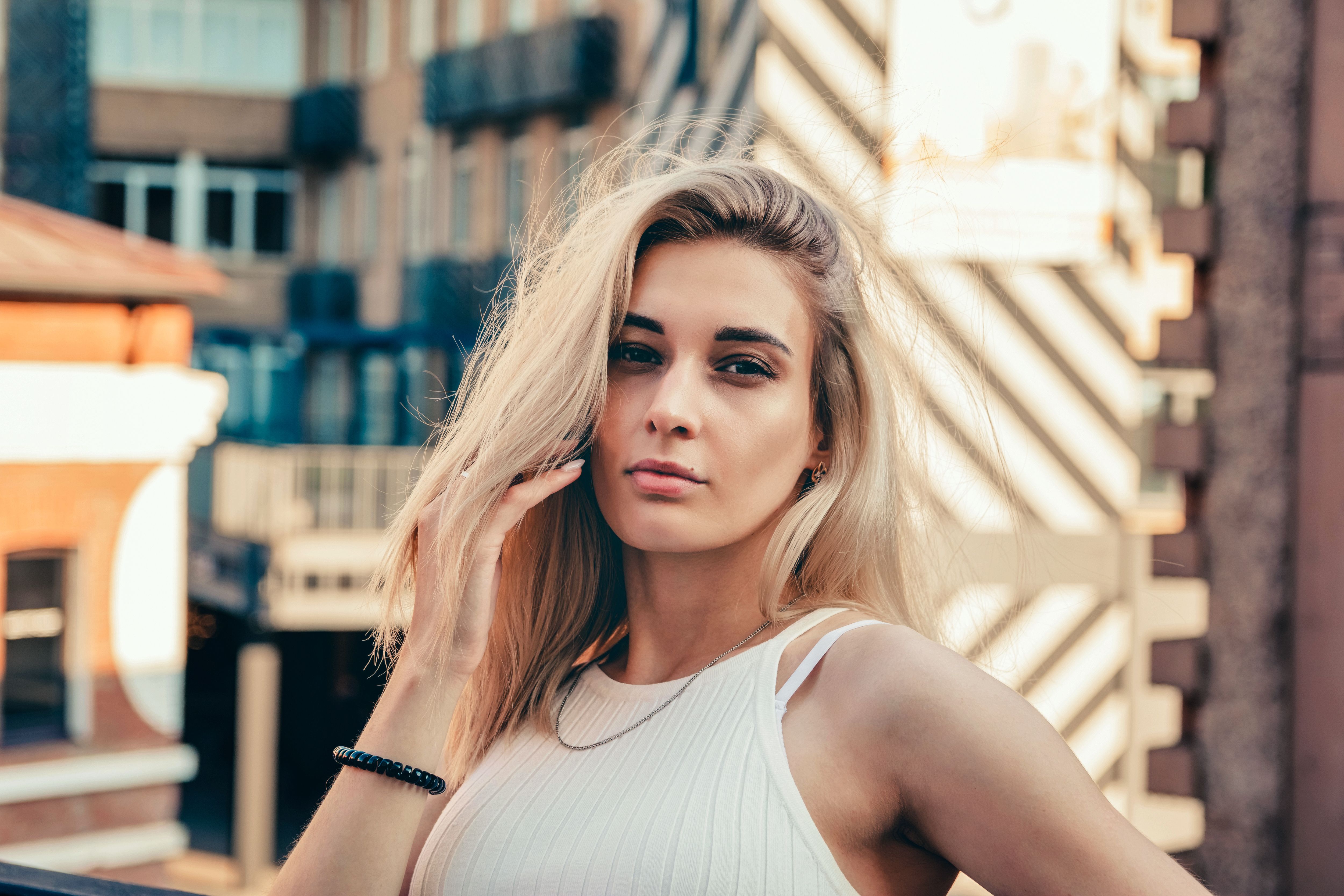 portrait of a young beautiful girl on a city street in summer portrait of a young beautiful girl on a city street in summer