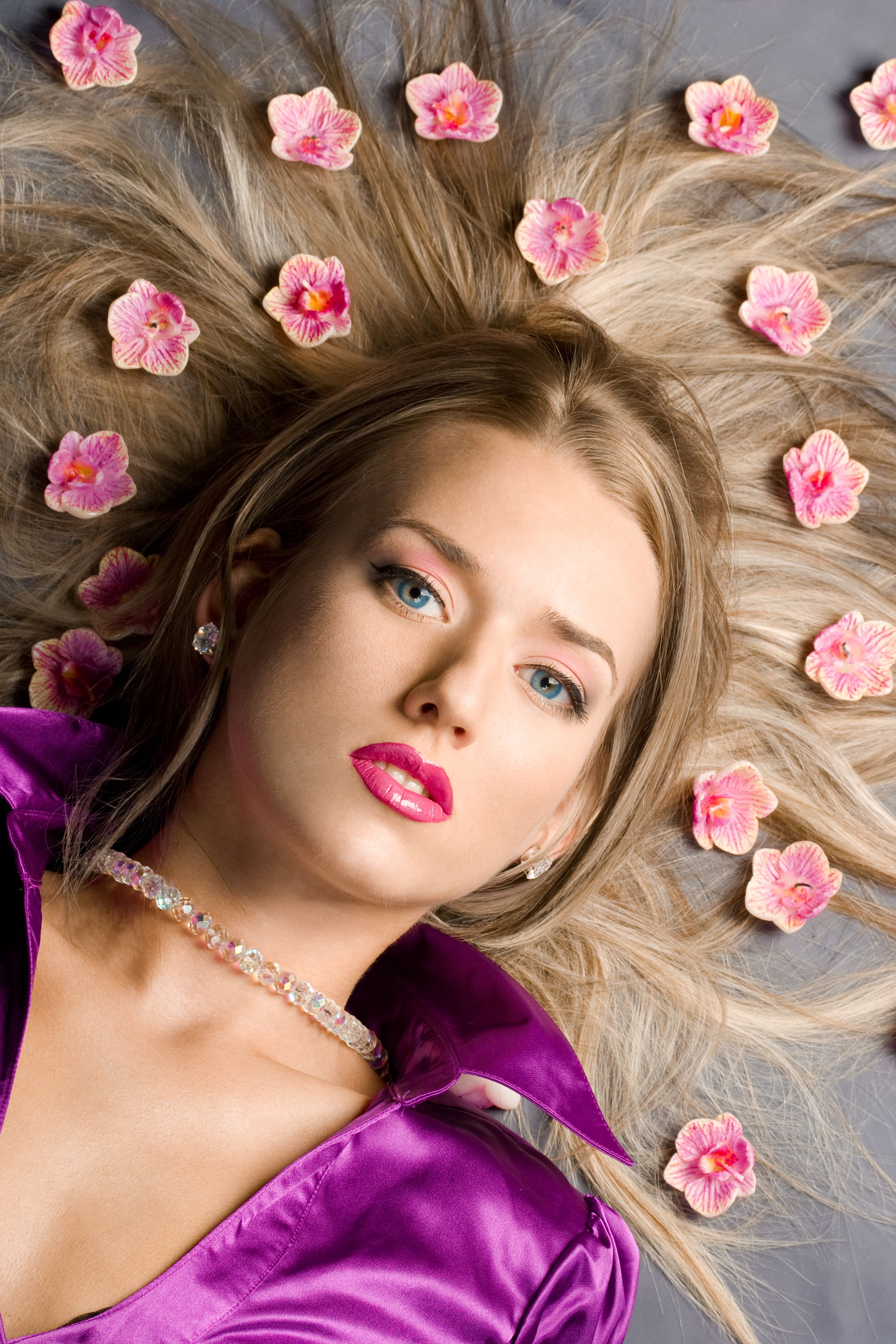 lying beautiful woman with pink flowers