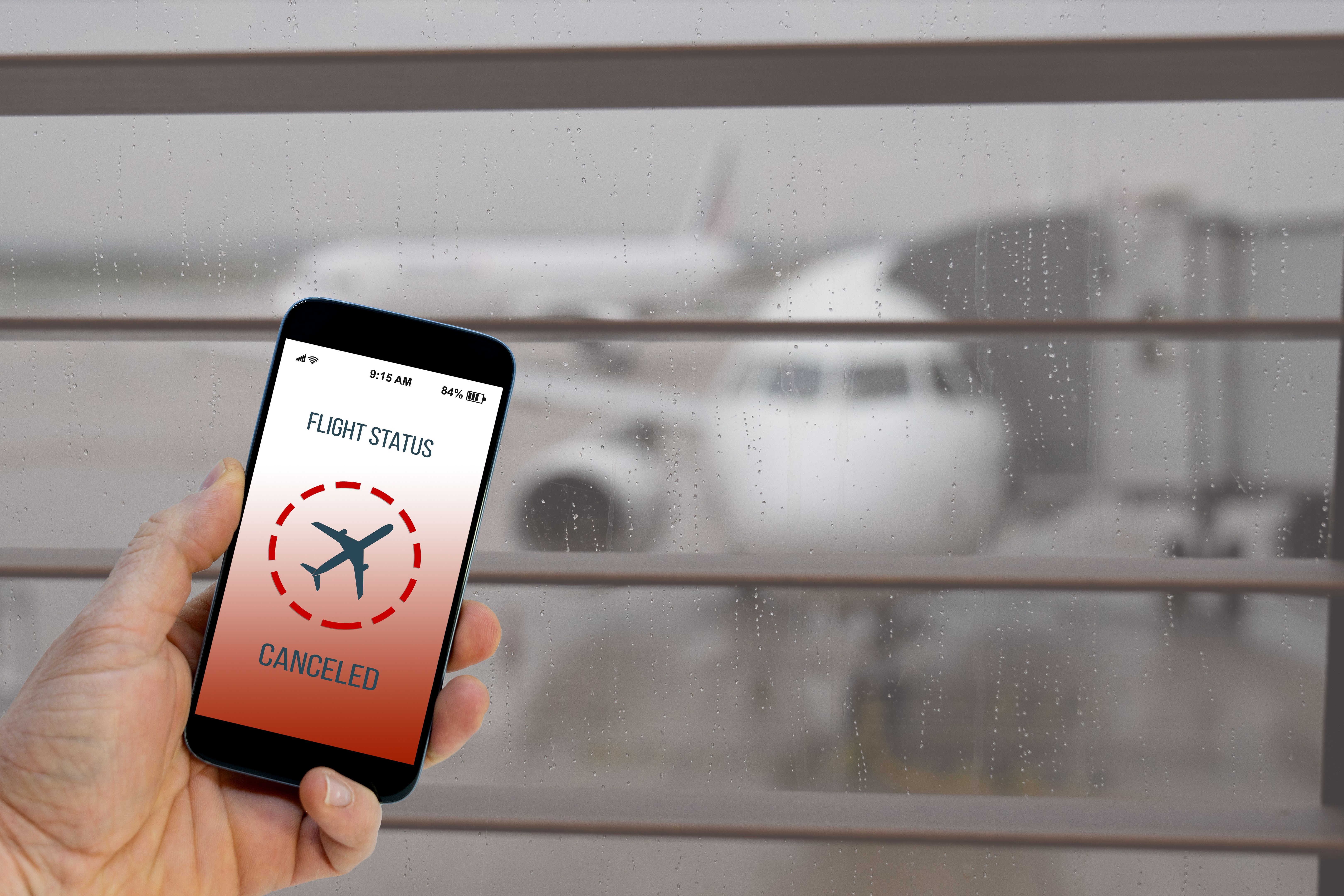 Flight canceled notification on Smartphone application announces bad news to tourist