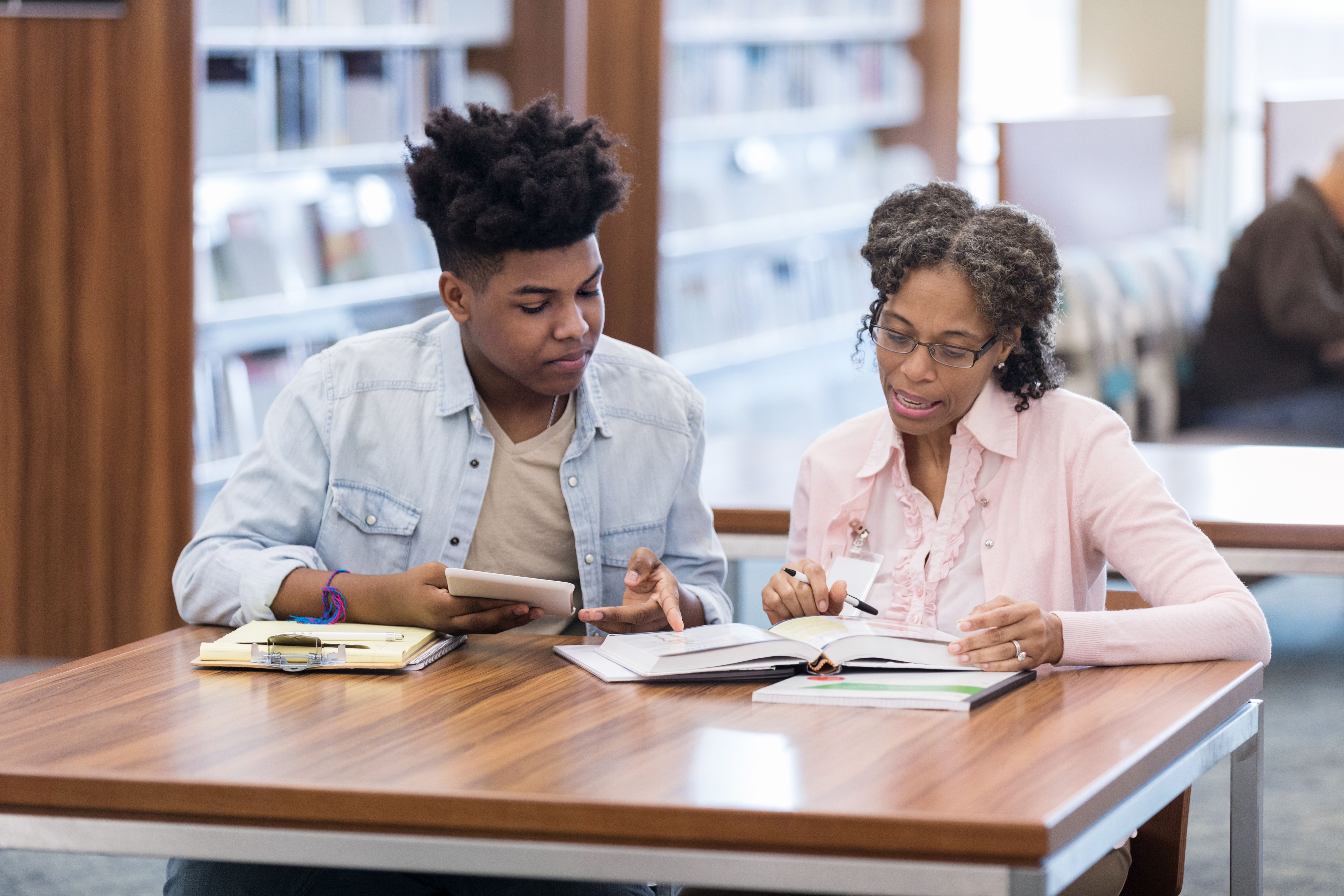 African American teacher helps student