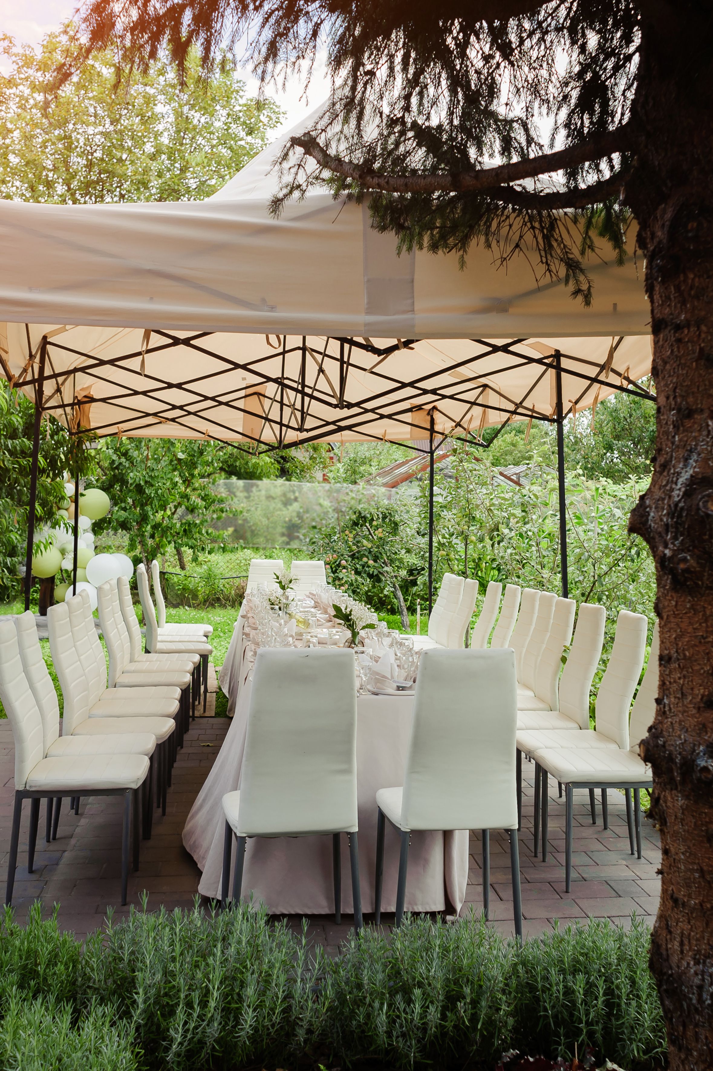 A summer tent with tables, food  and chairs on the wedding day