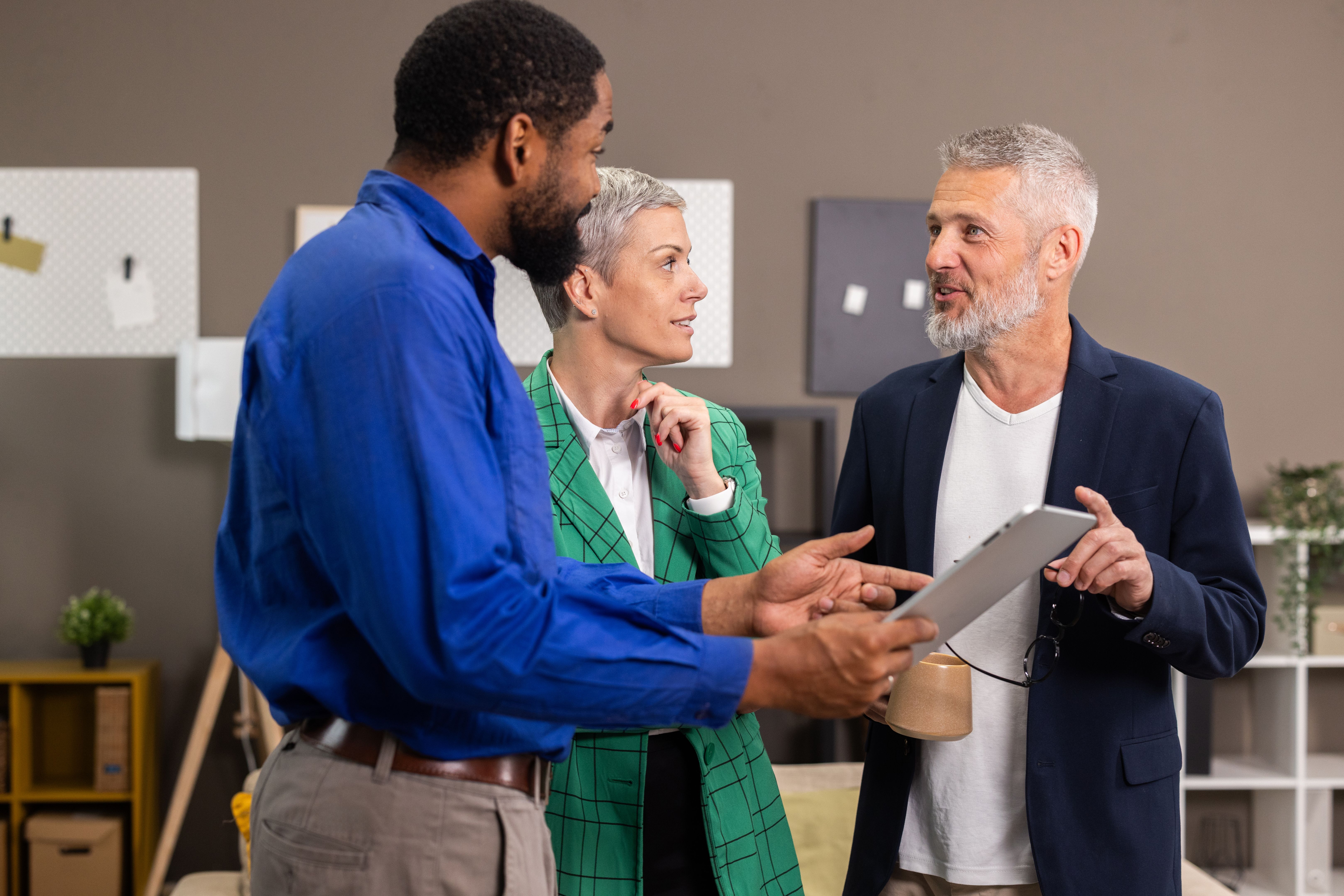 Business people discussing work using digital tablet in office