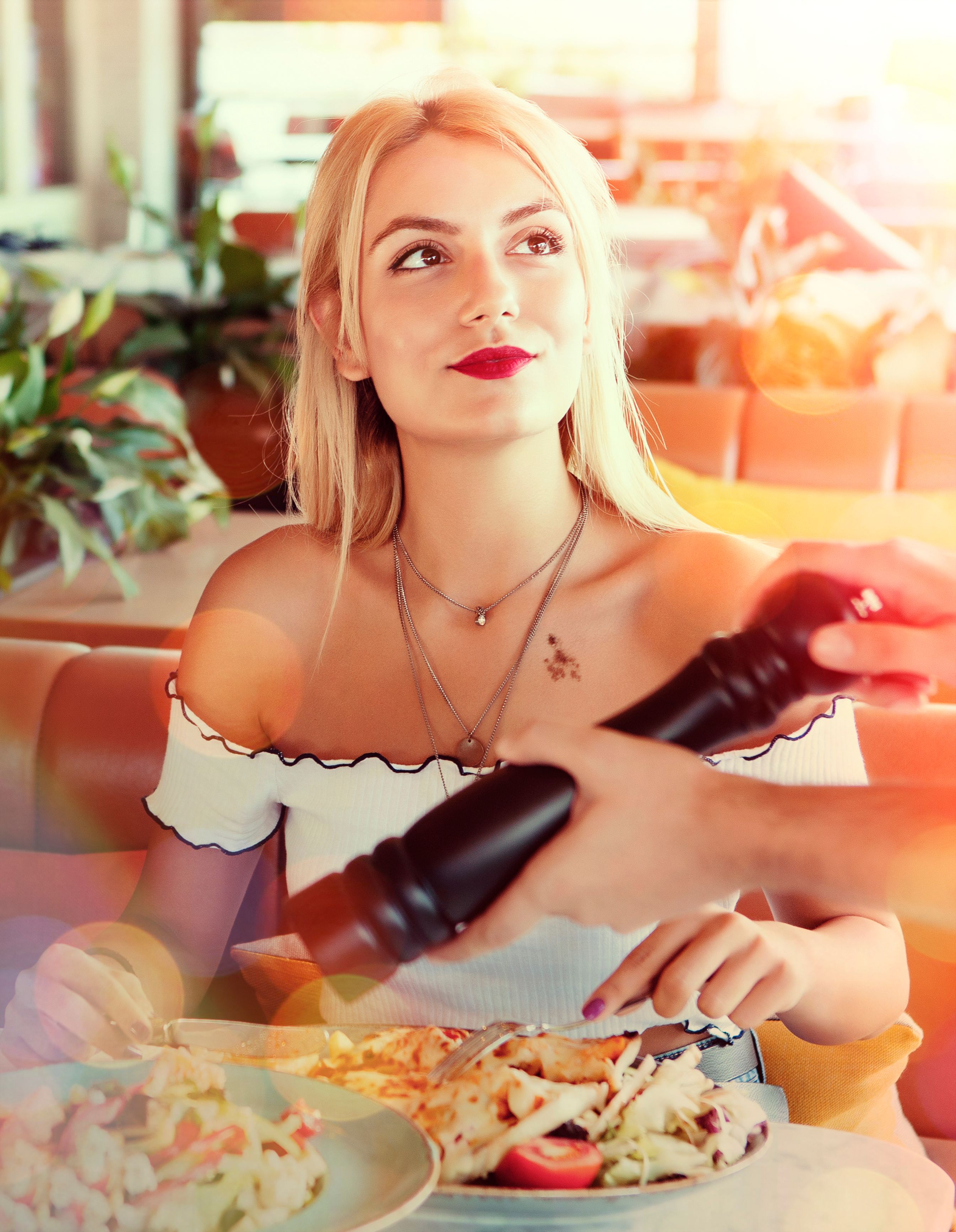 Beautiful woman having lunch at a restaurant. Warm bright sunshine filter Beautiful woman having lunch at a restaurant. Warm bright sunshine filter