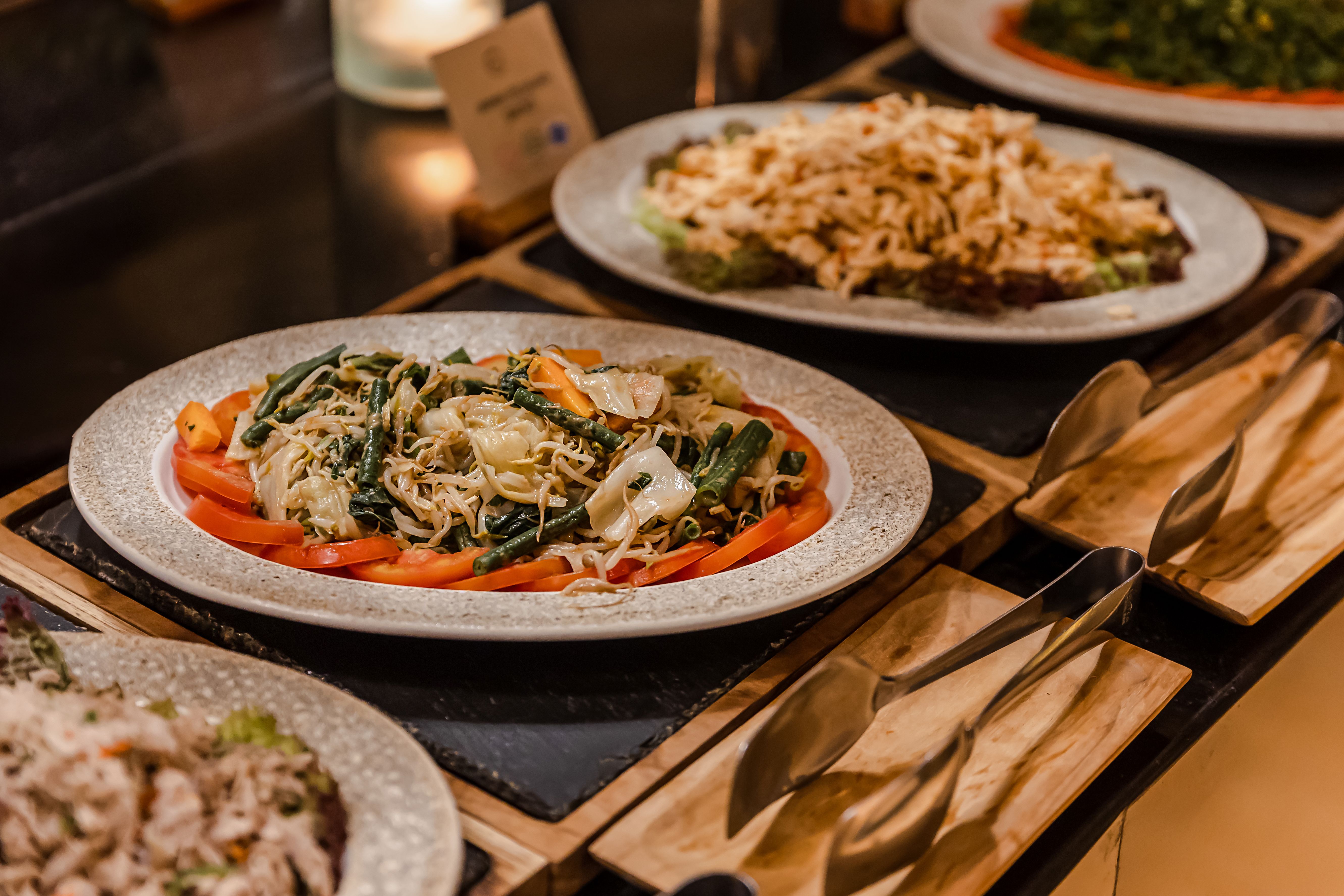 Salad bar among catering banquet table. Variety of snacks, appetizers, seafood and cooked meals displayed as buffet for wedding, Christmas, business corporate, birthday party or other event Salad bar among catering banquet table. Variety of snacks, appetizers, seafood and cooked meals displayed as buffet for wedding, Christmas, business corporate, birthday party or other event
