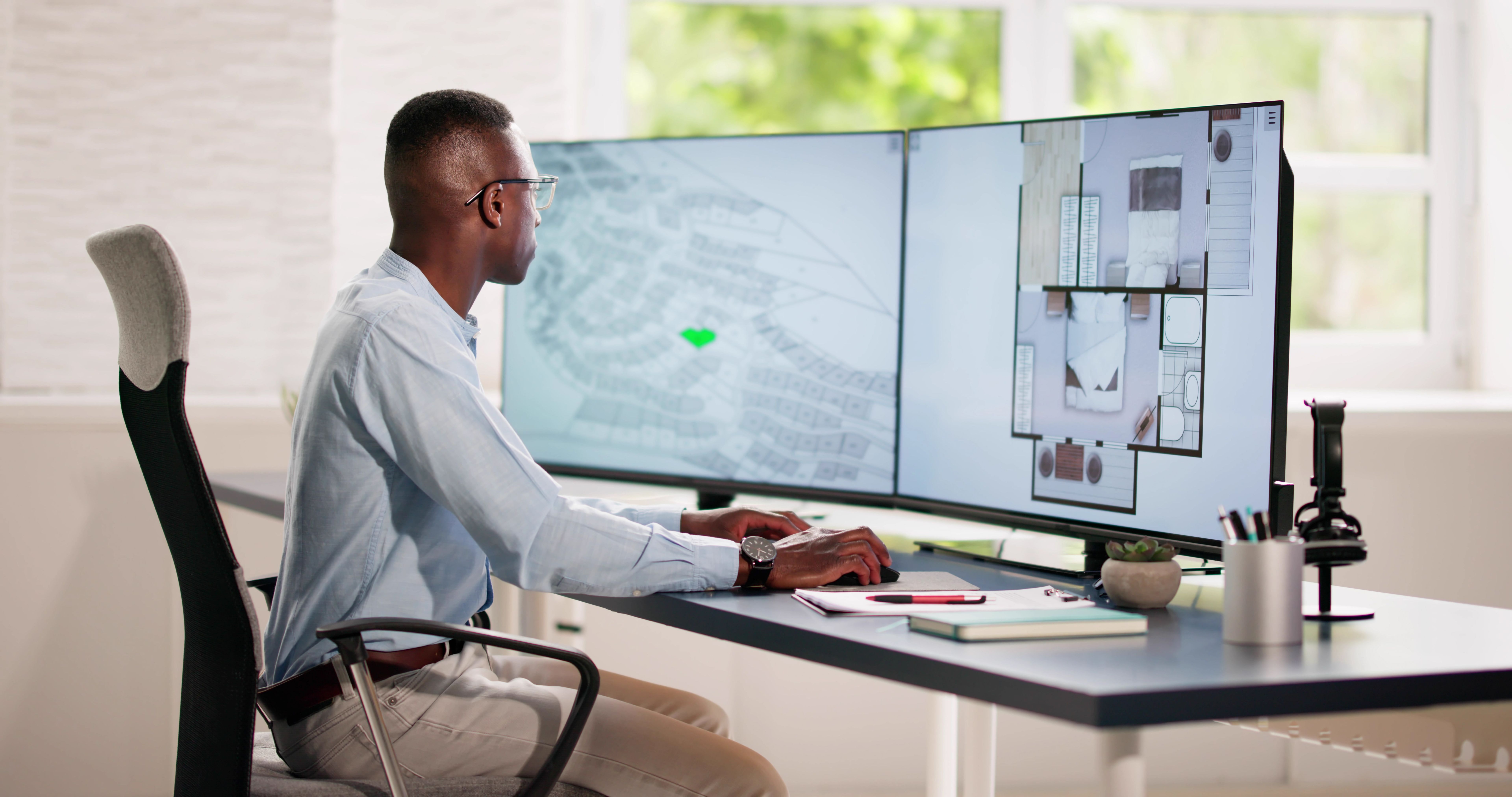 Developer Looking At Land Plot Map