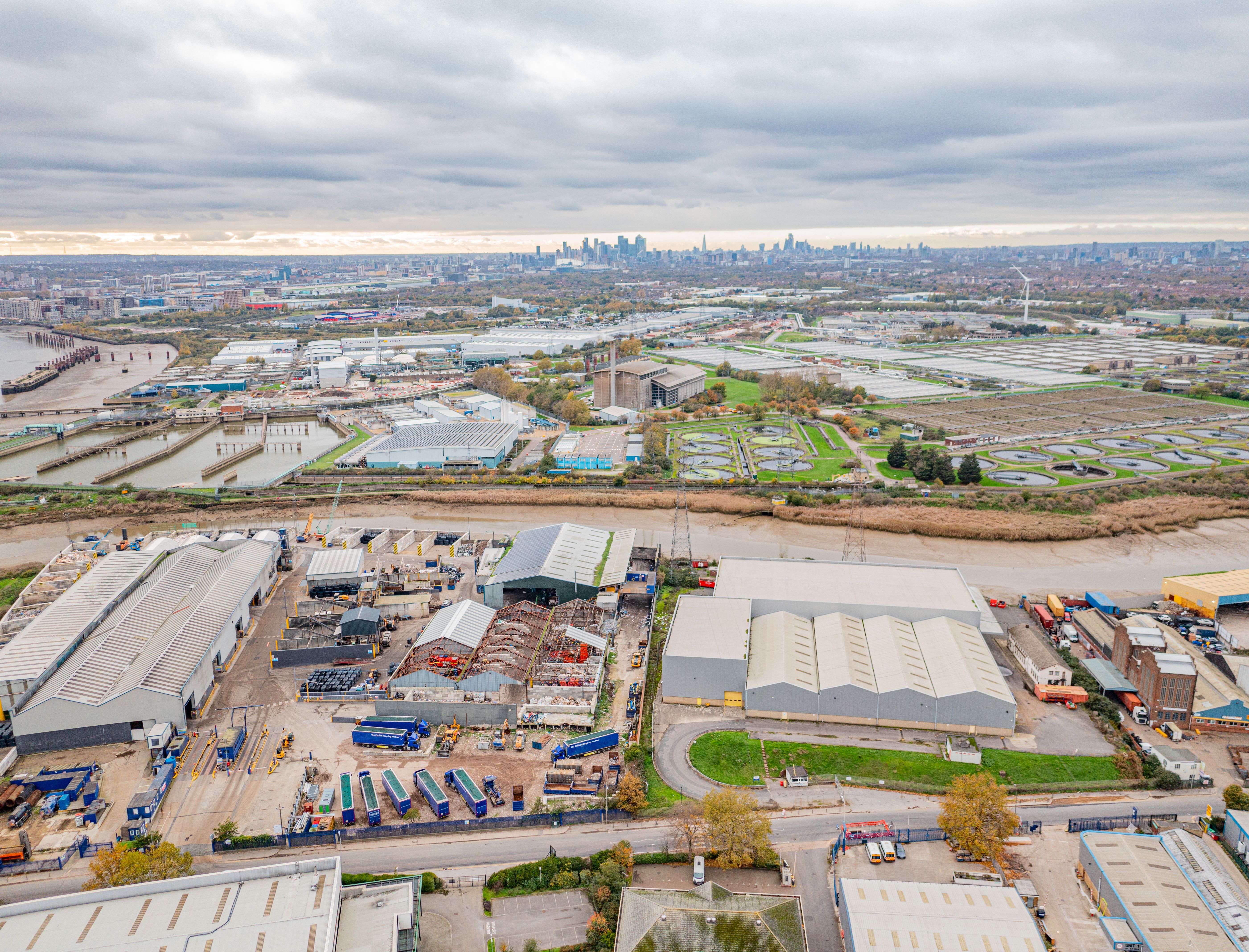 London Skyline with Barking commercial units and sewage works in foreground.