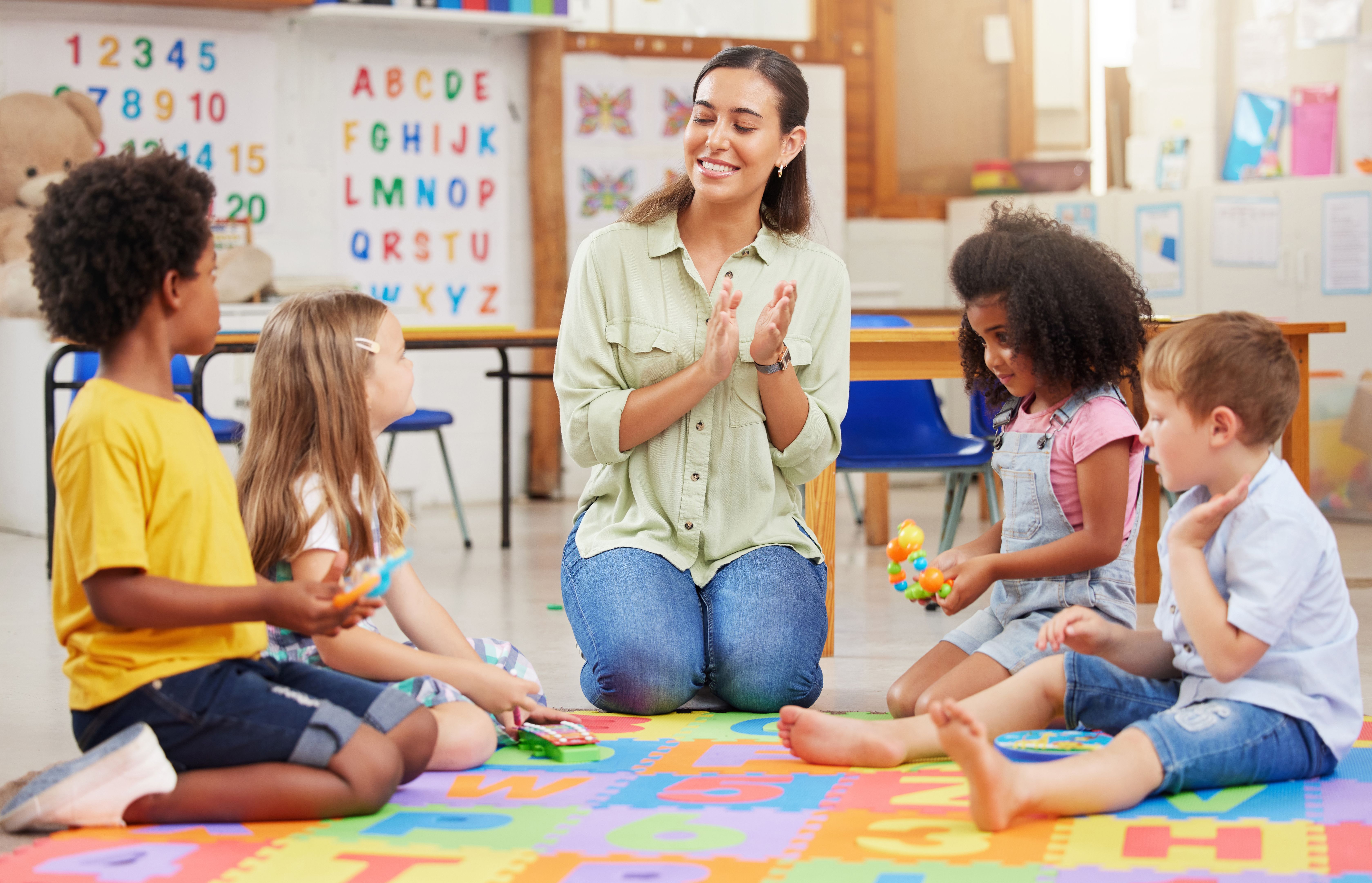 Shot of a teacher singing with her preschool children Shot of a teacher singing with her preschool children
