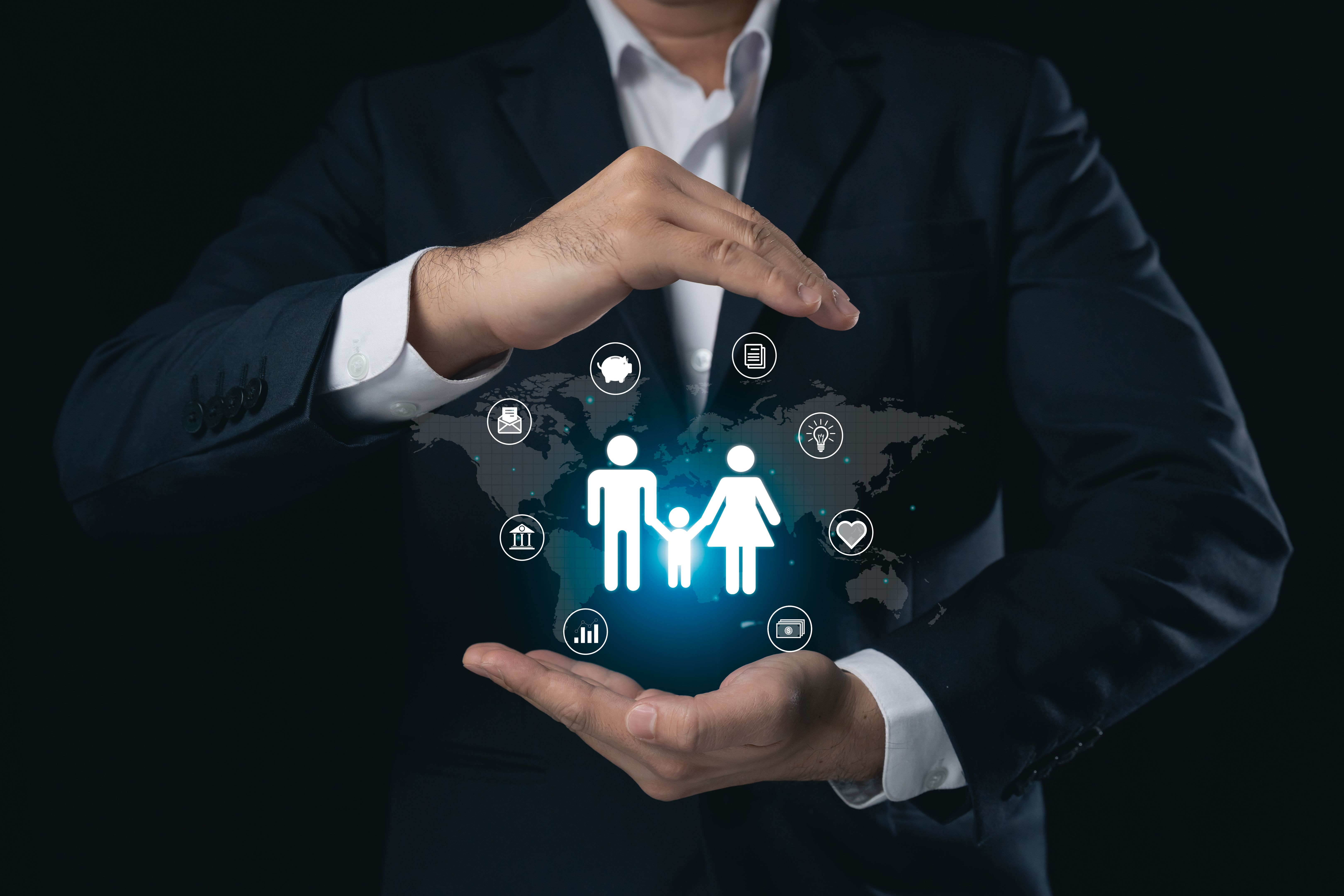 Professional man protecting family icons with virtual hands, symbolizing care, support, and global connection in a digital landscape