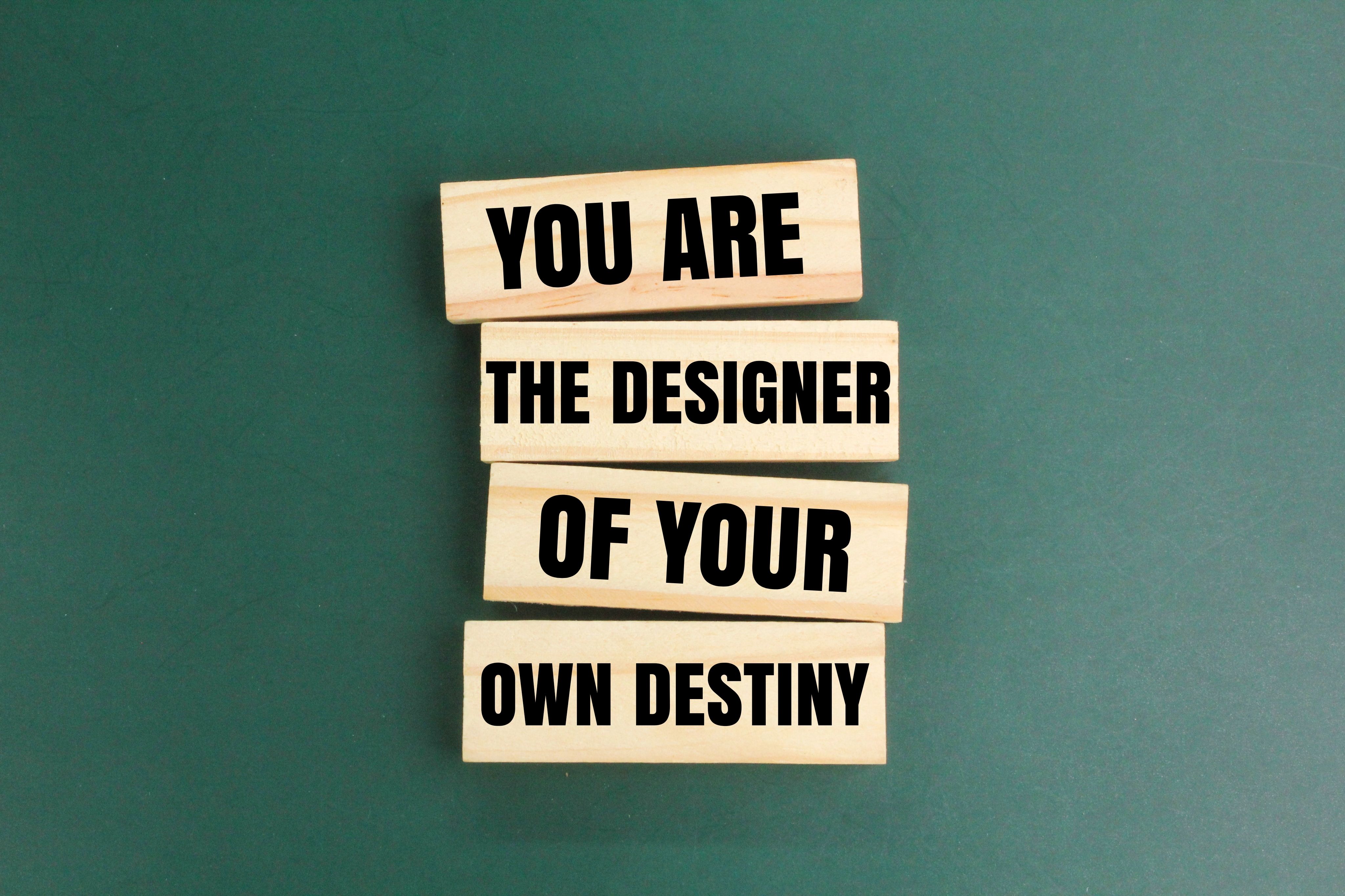 wood with the words YOU ARE THE DESIGNER OF YOUR OWN DESTINY. Inspirational concept. Motivational and inspirational quote concept