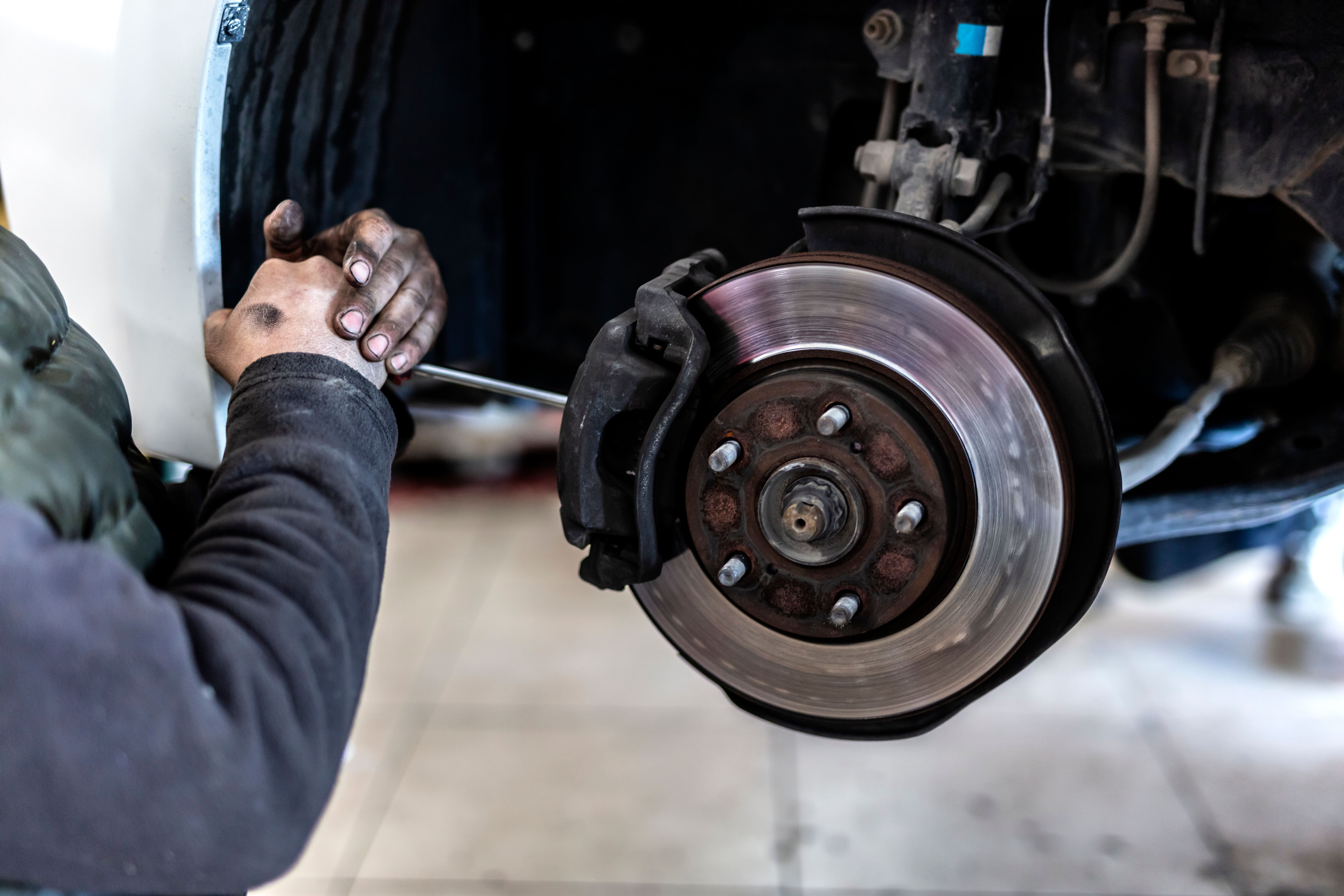 mechanic repairing brakes