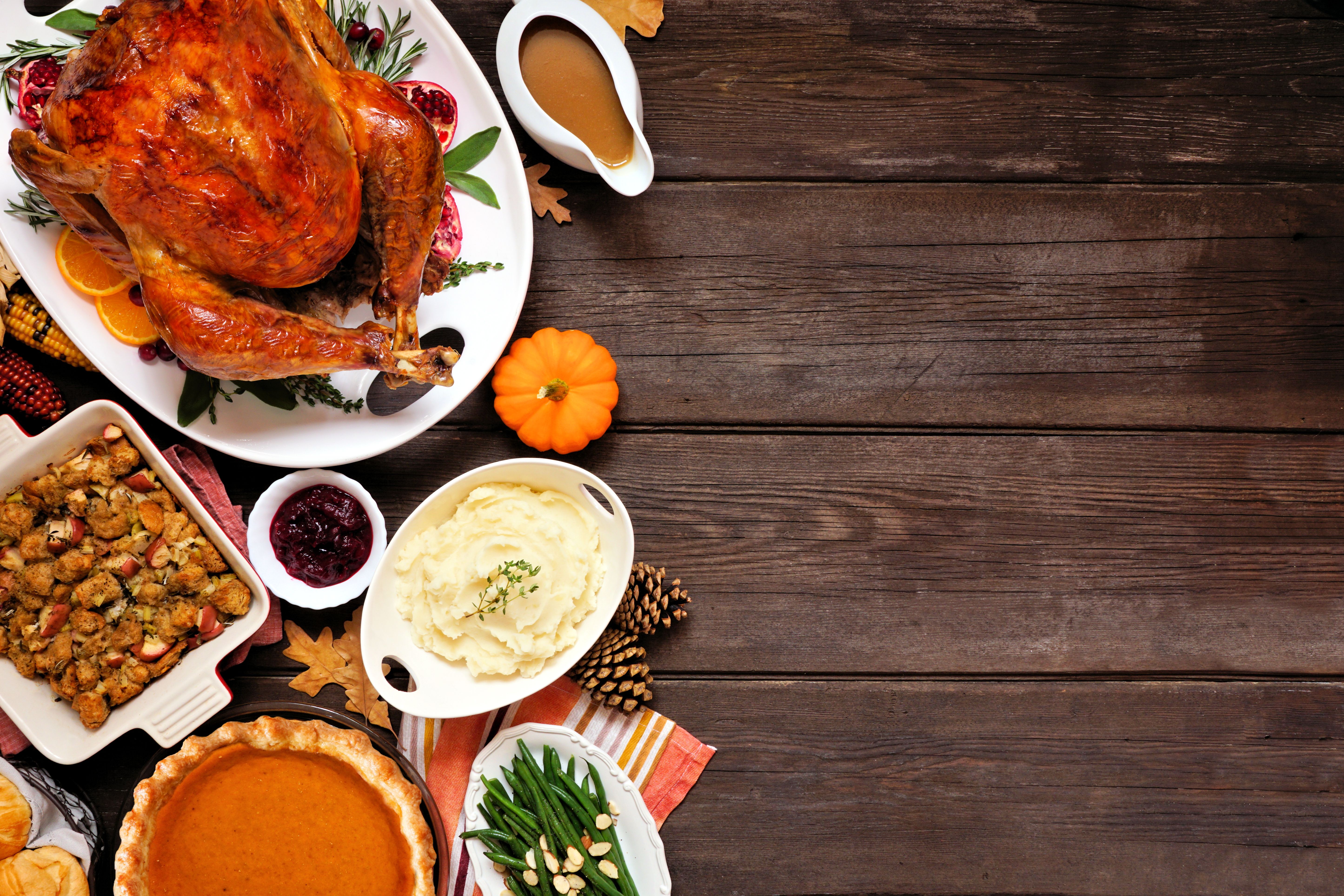 Classic Thanksgiving turkey dinner. Top down view side border on a dark wood background with copy space. Classic Thanksgiving turkey dinner. Top down view side border on a dark wood background with copy space.