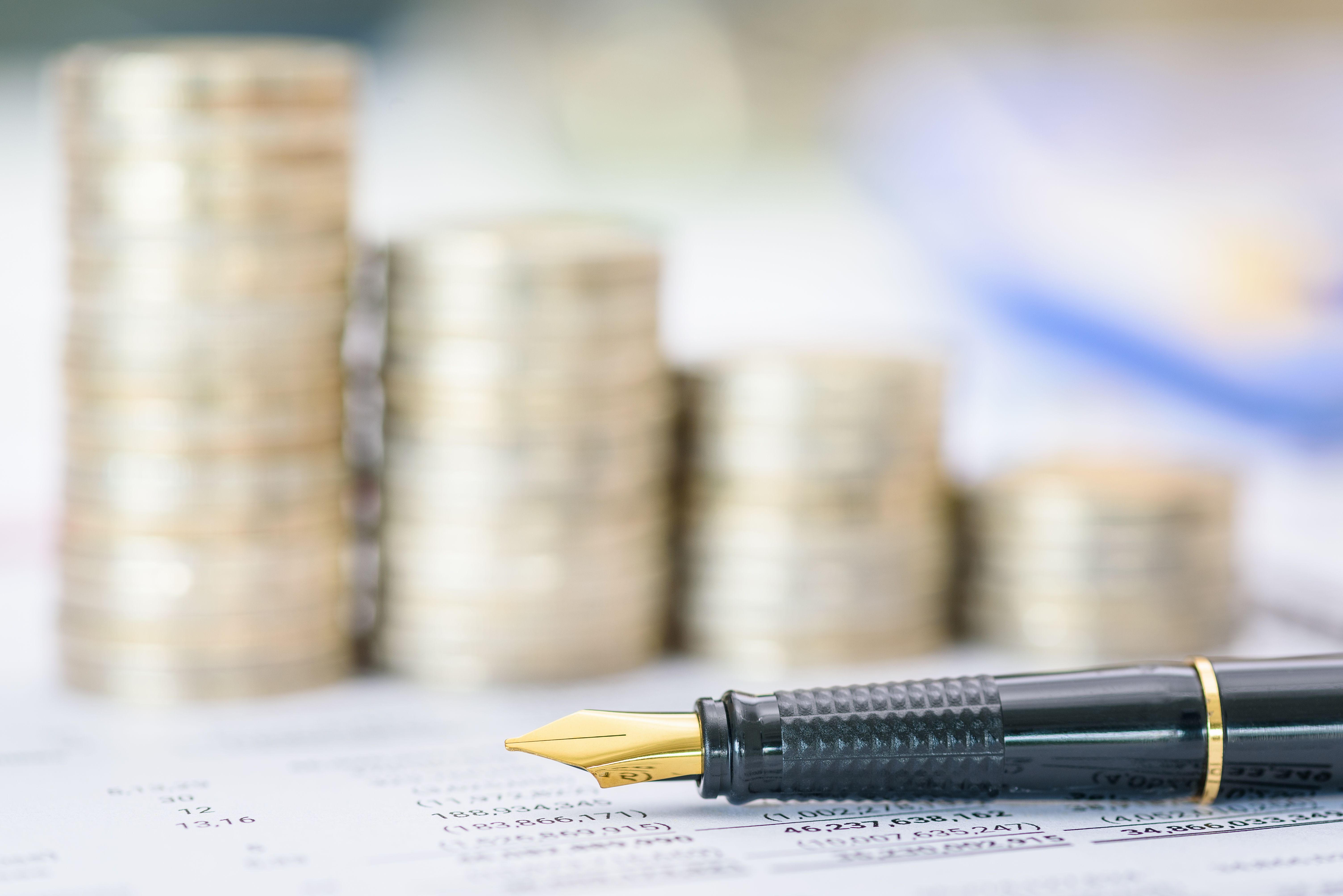 Pen atop a business or corporate financial report, anticipating review by financial and investment experts prior to public disclosure. Illustrating financial analysis and investment insight concept. Pen atop a business or corporate financial report, anticipating review by financial and investment experts prior to public disclosure. Illustrating financial analysis and investment insight concept.