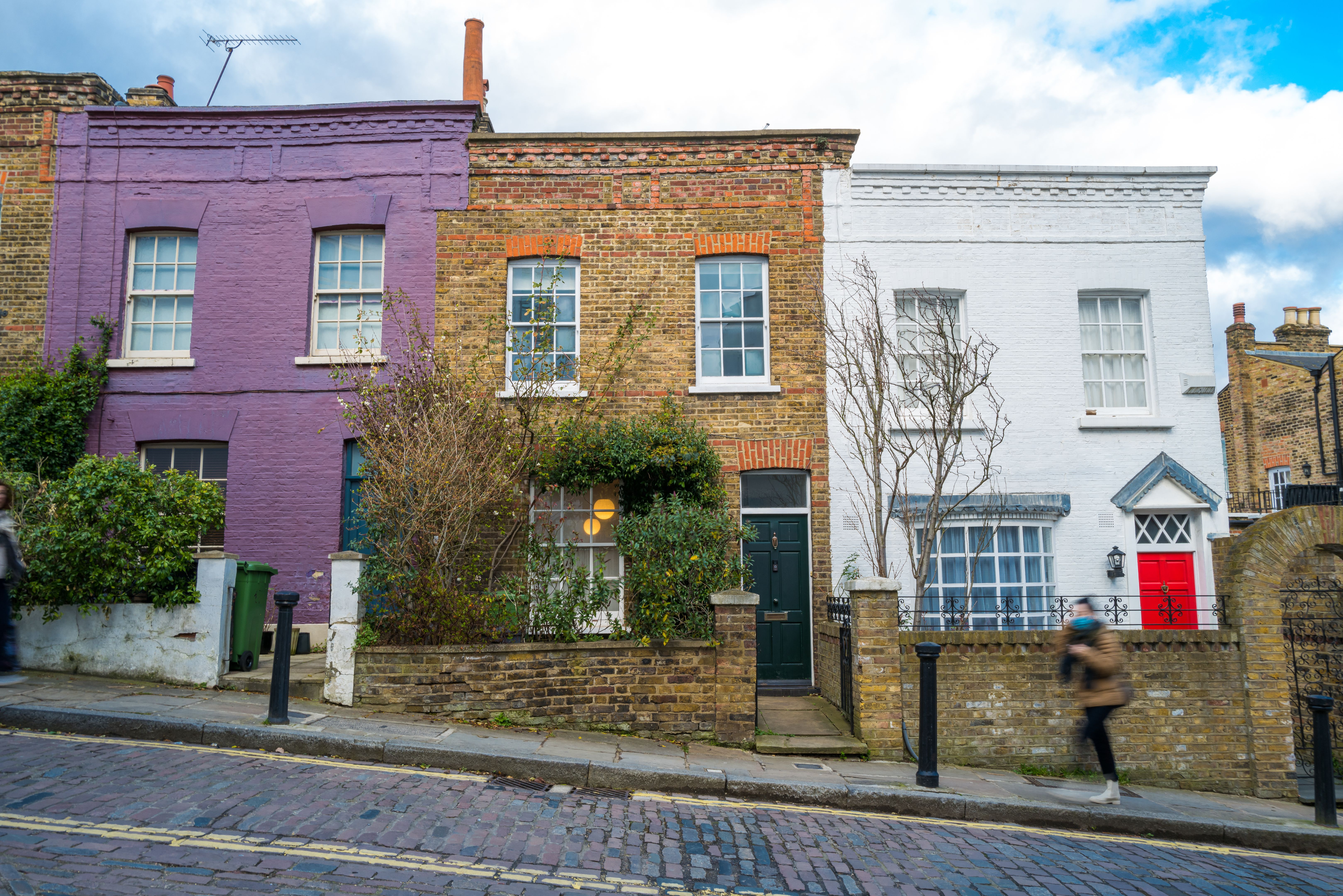 Blurred motion of woman walking on traditional London street