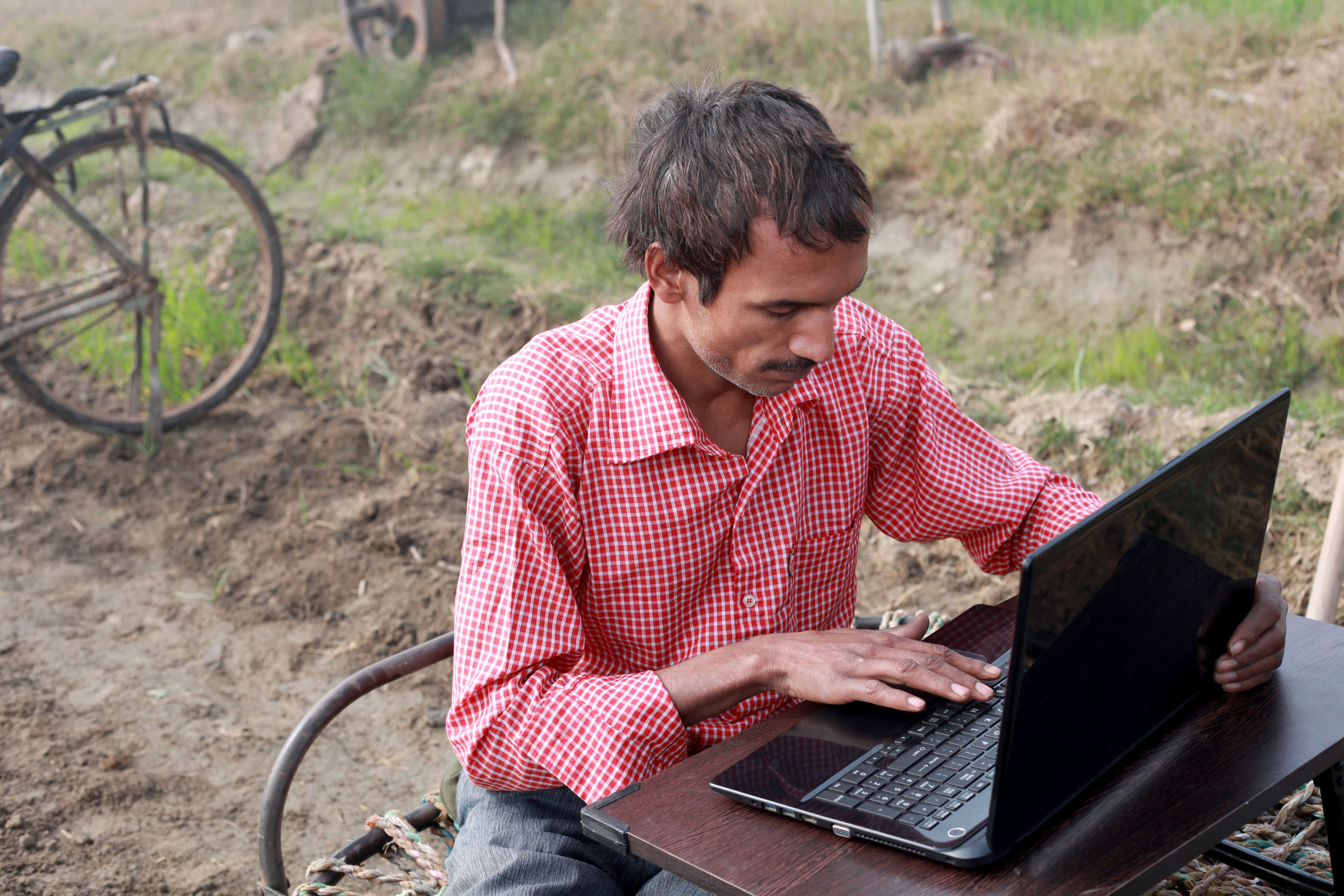 Poor men using laptop