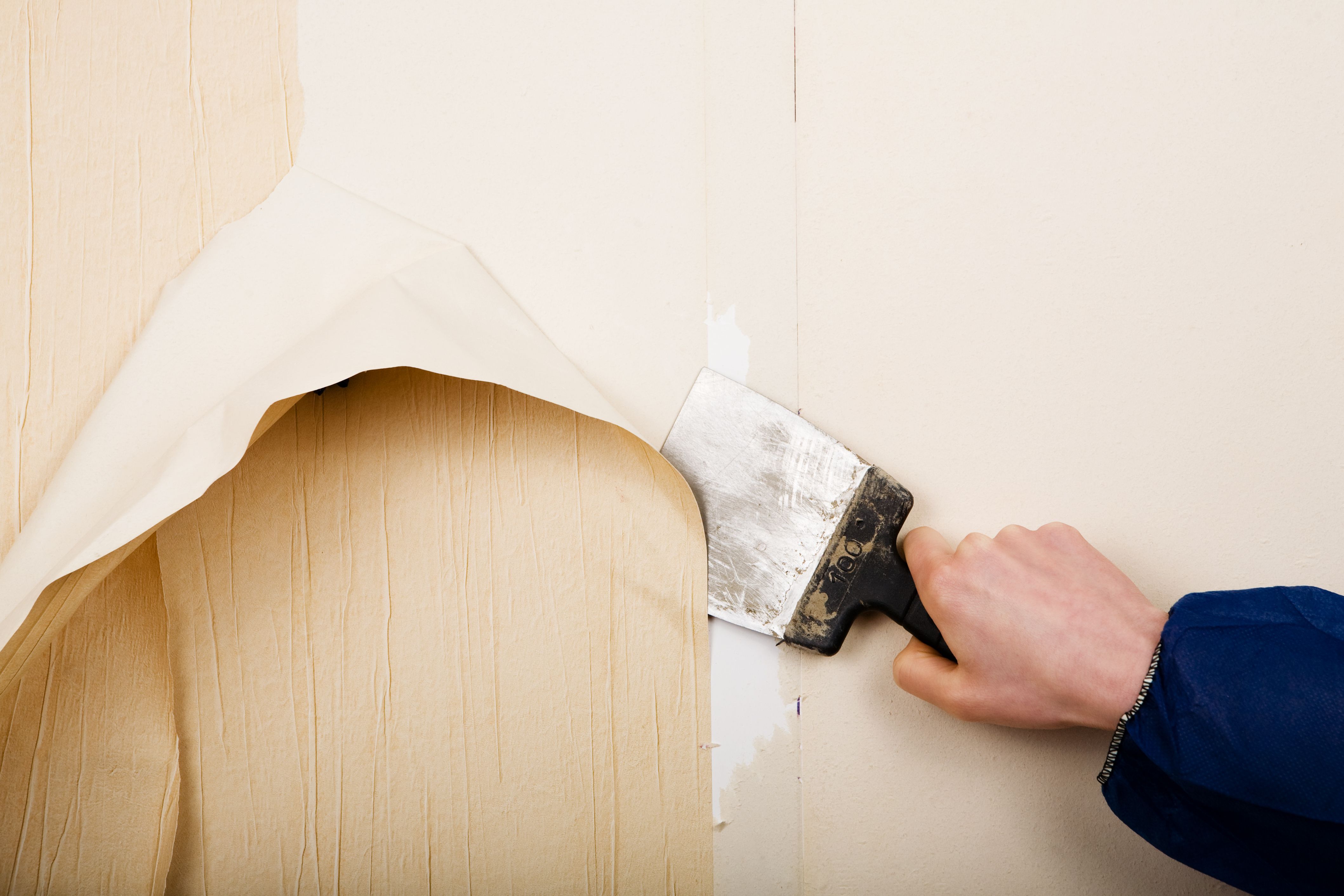 removing wallpaper with scraper