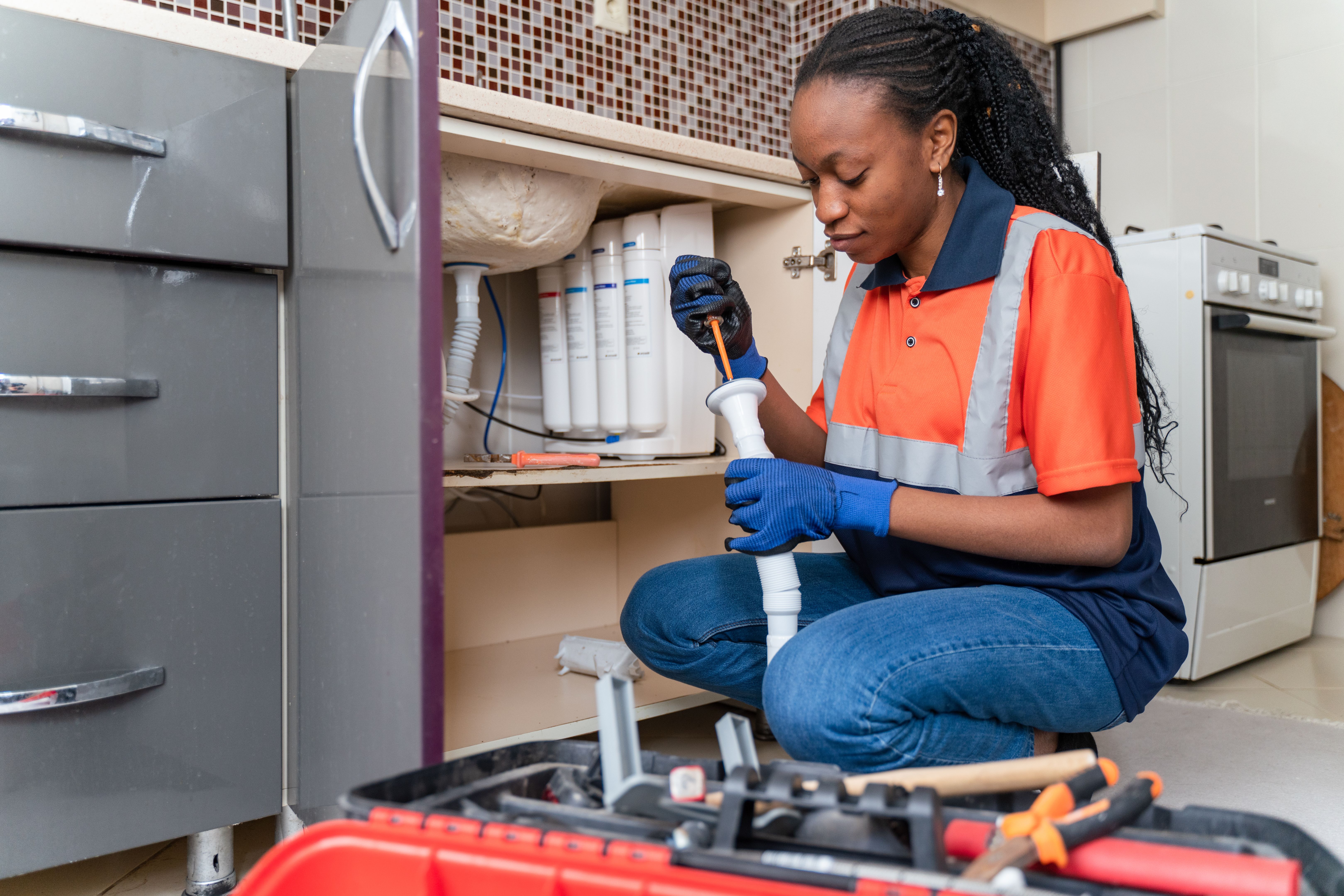 woman fixing appliance