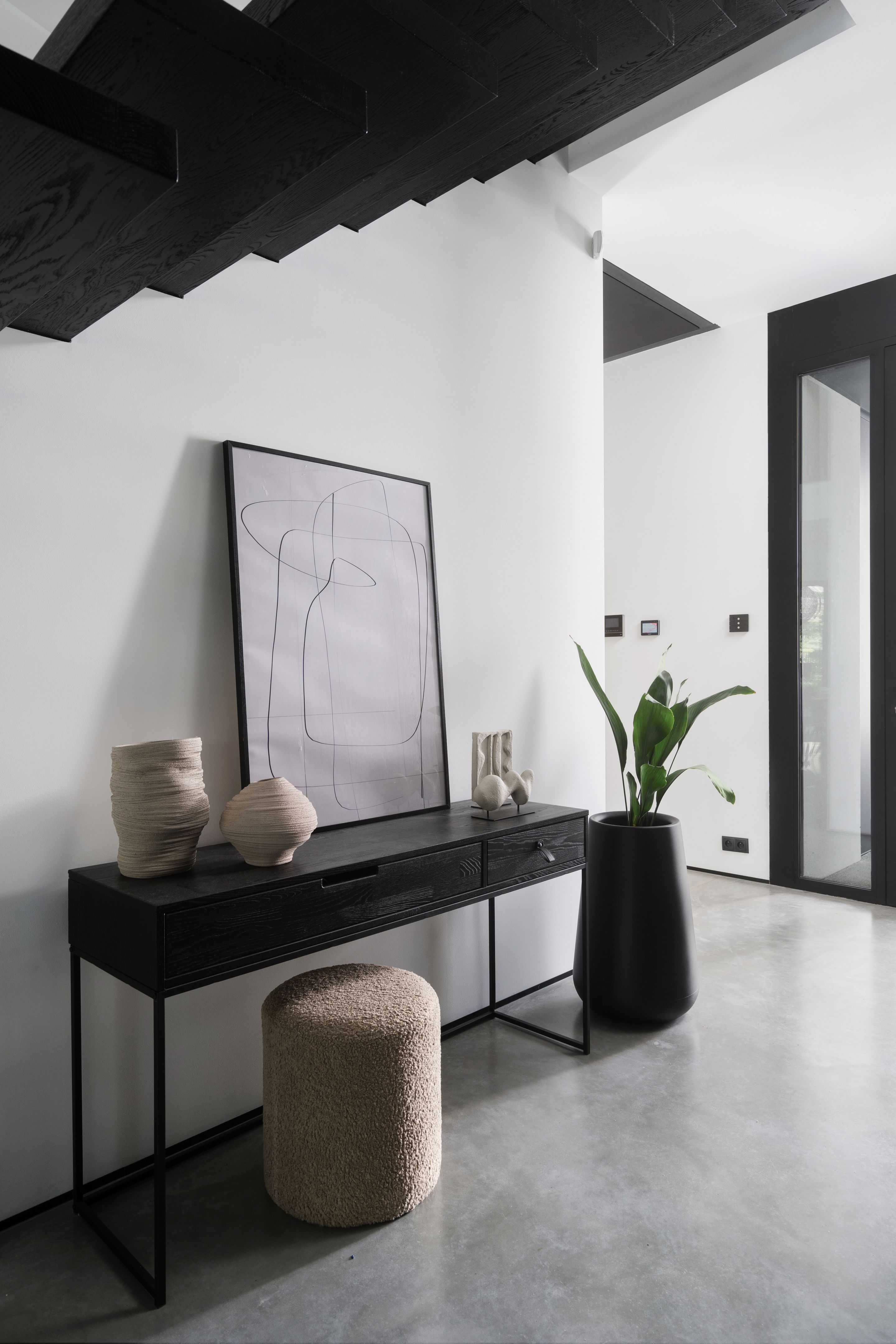 Modern minimalist hallway with sleek console table and artistic decor in contemporary home