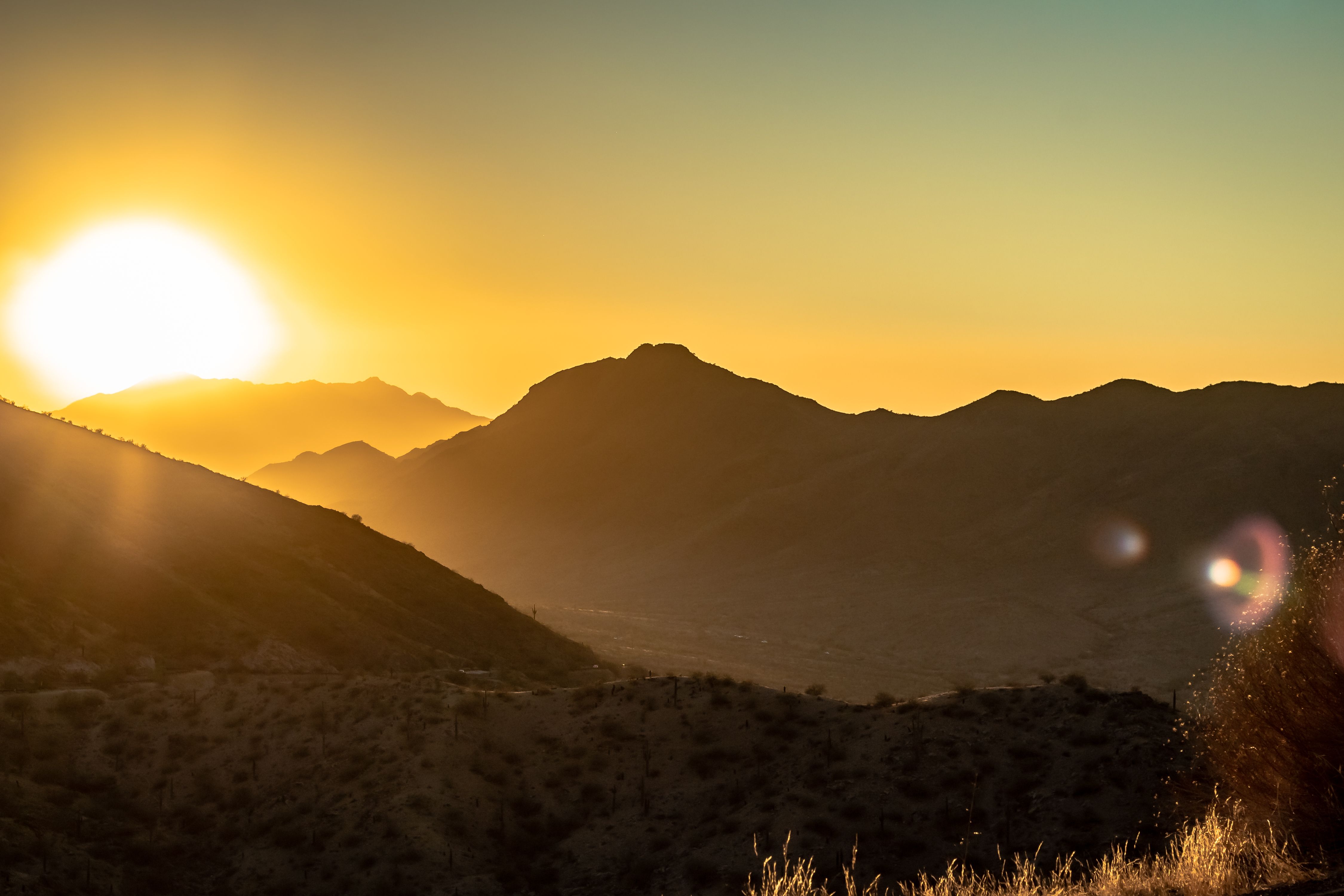 Yellow sunset in the Phoenix Arizona Sonoran Desert mountains. Photo taken during golden hour