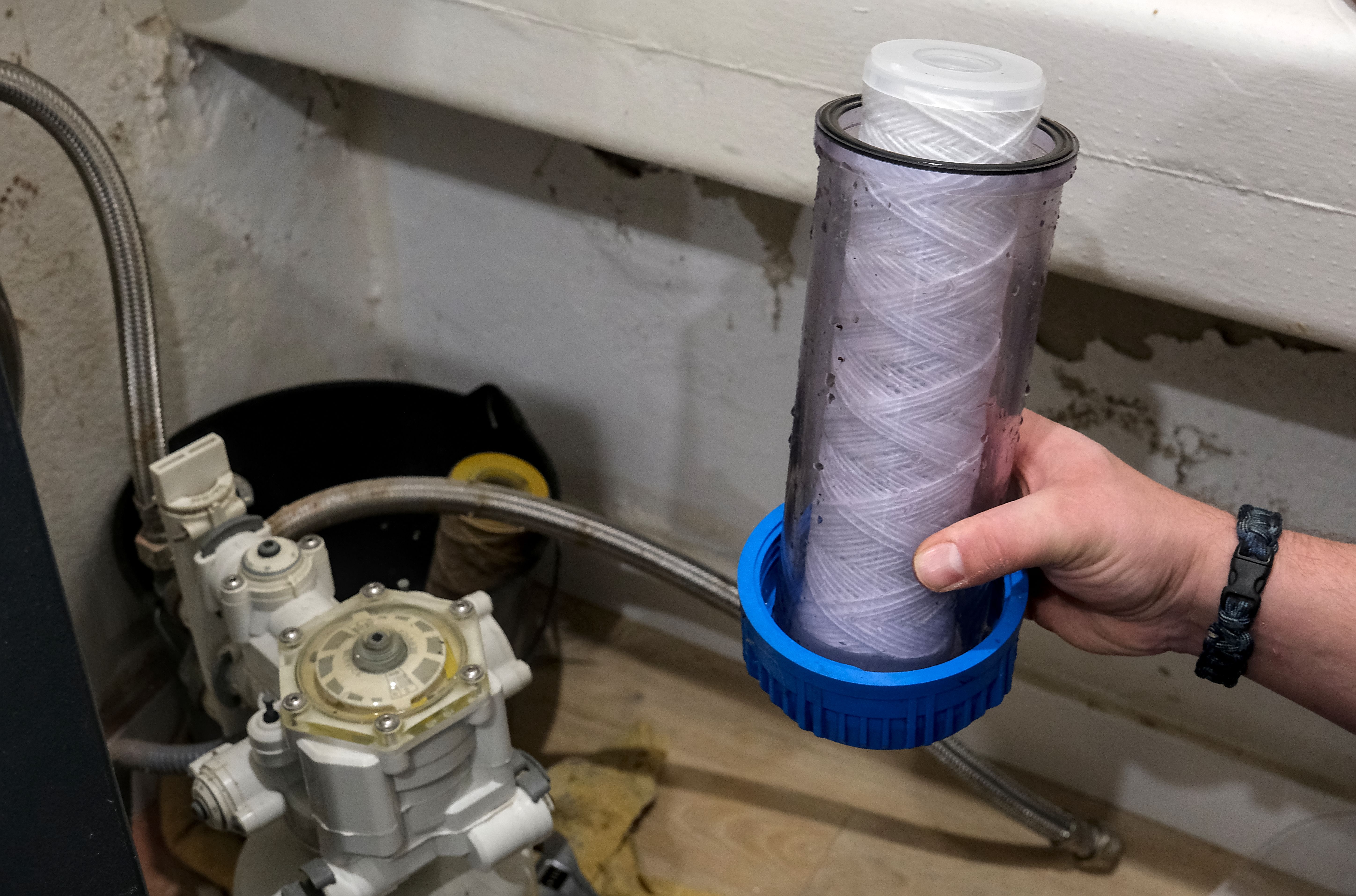 plumber installing filter