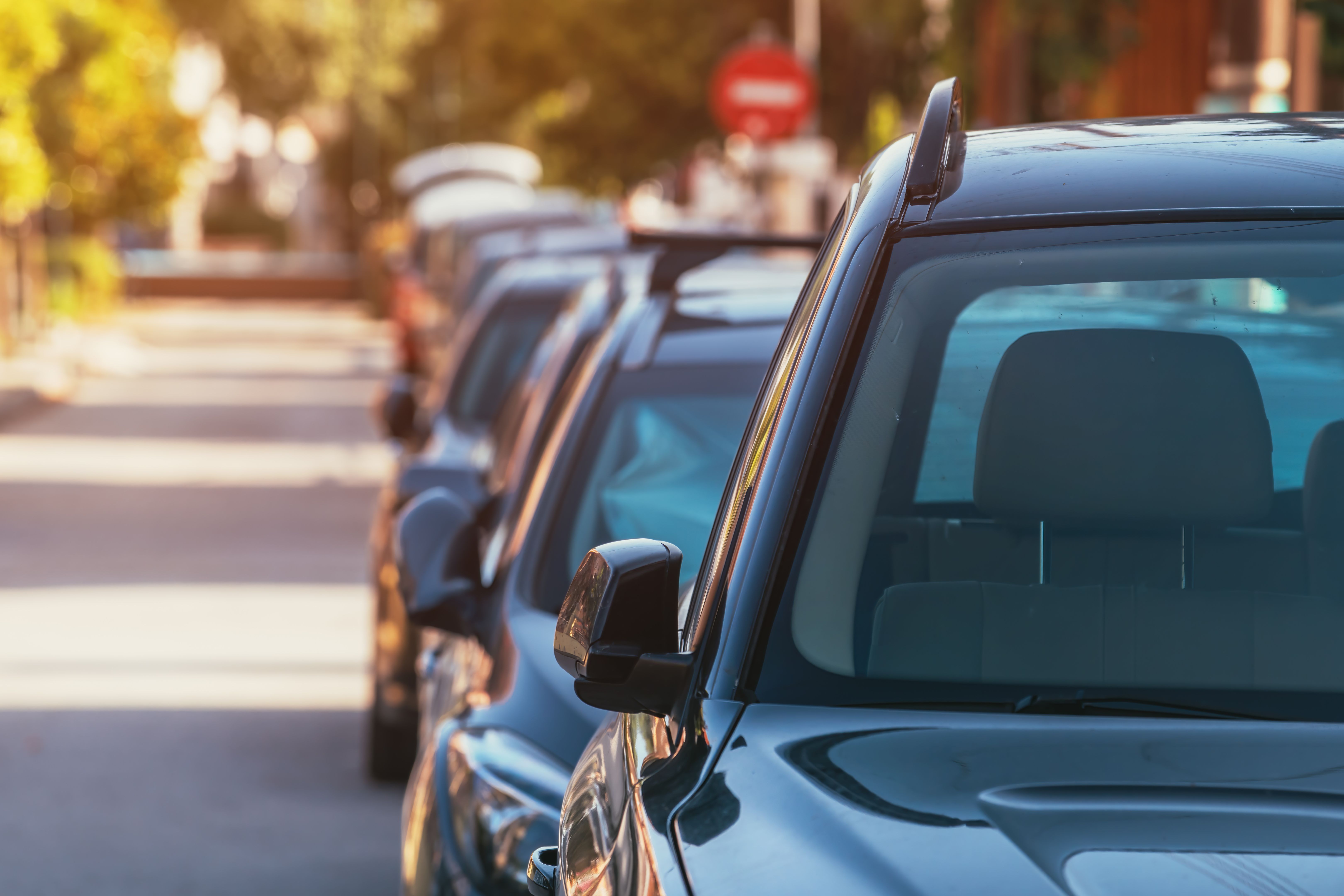 Cars parked in a row on the street in Vrasna, Greece Cars parked in a row on the street in Vrasna, Greece