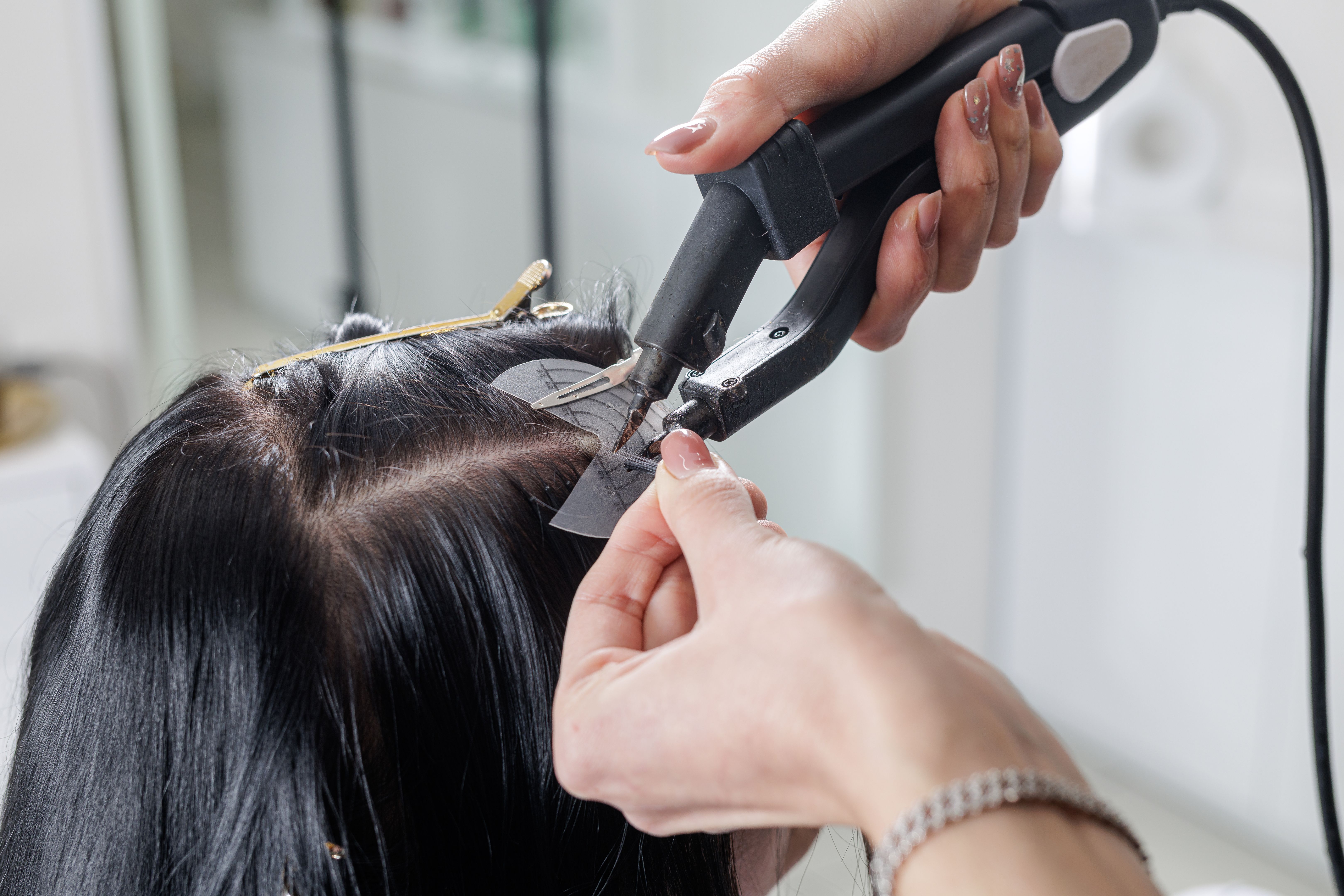 hands applying extensions