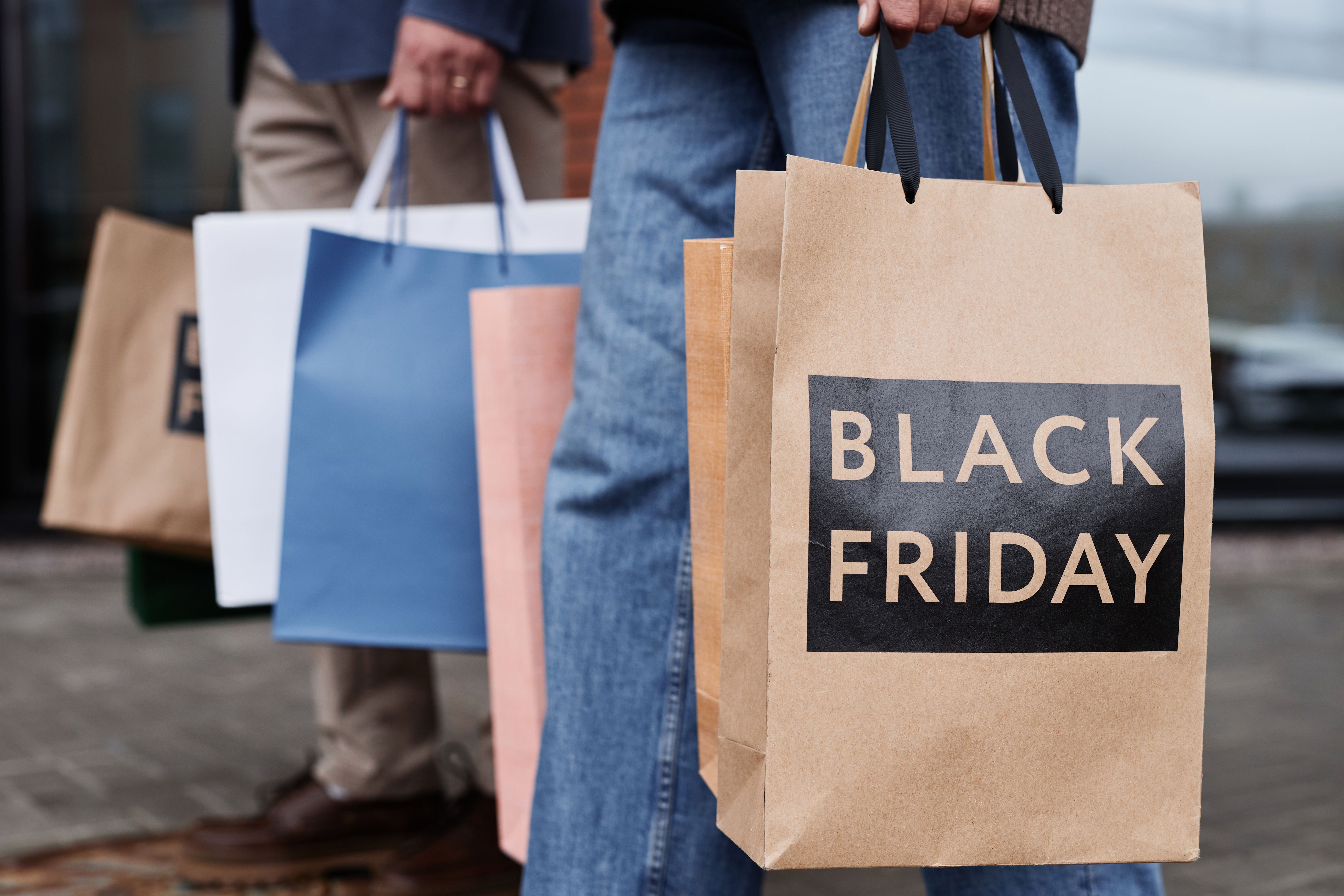 Close up of couple holding Black friday shopping bags