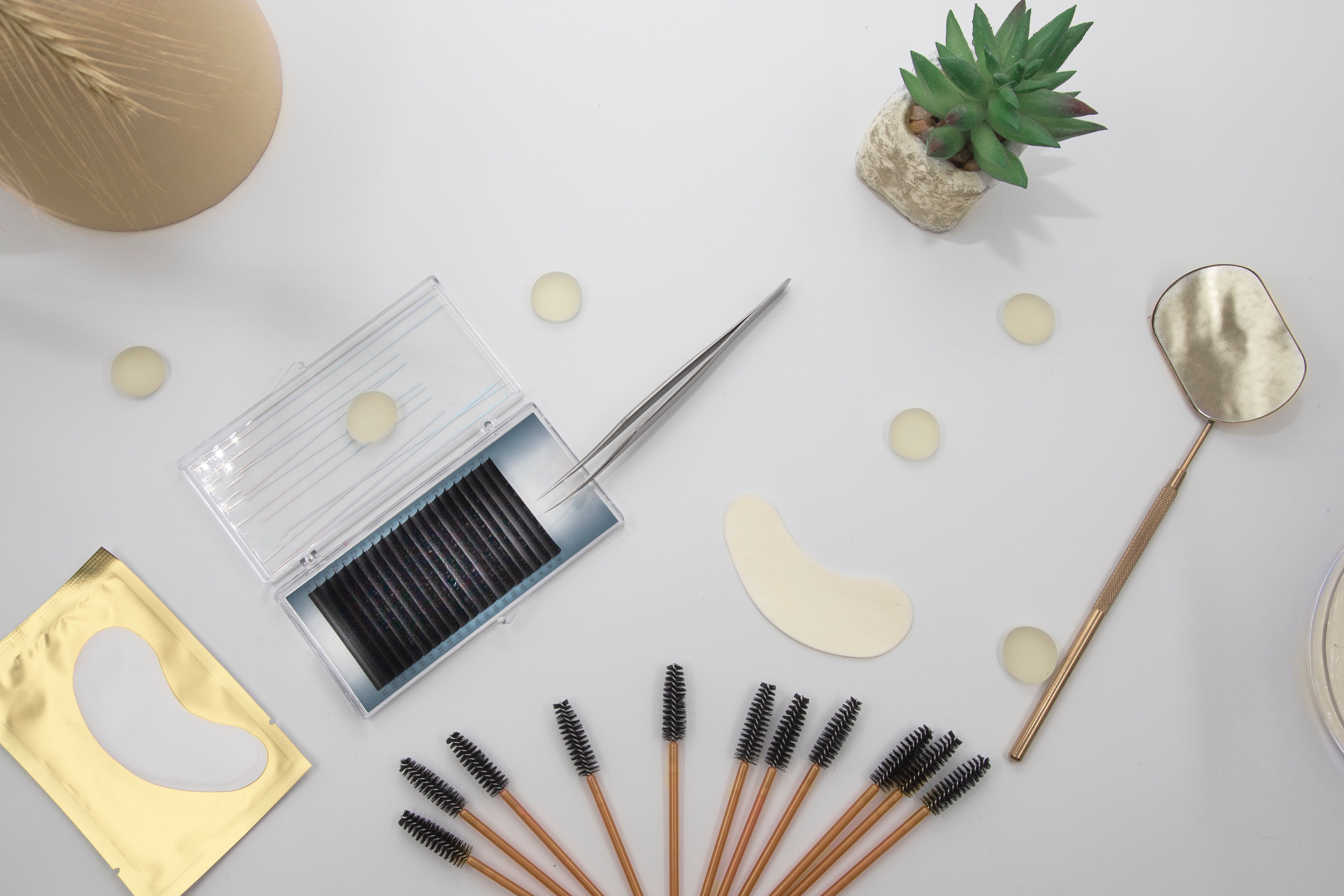 Eyelash extension tools and accessories on a light background Eyelash extension tools and accessories on a light background