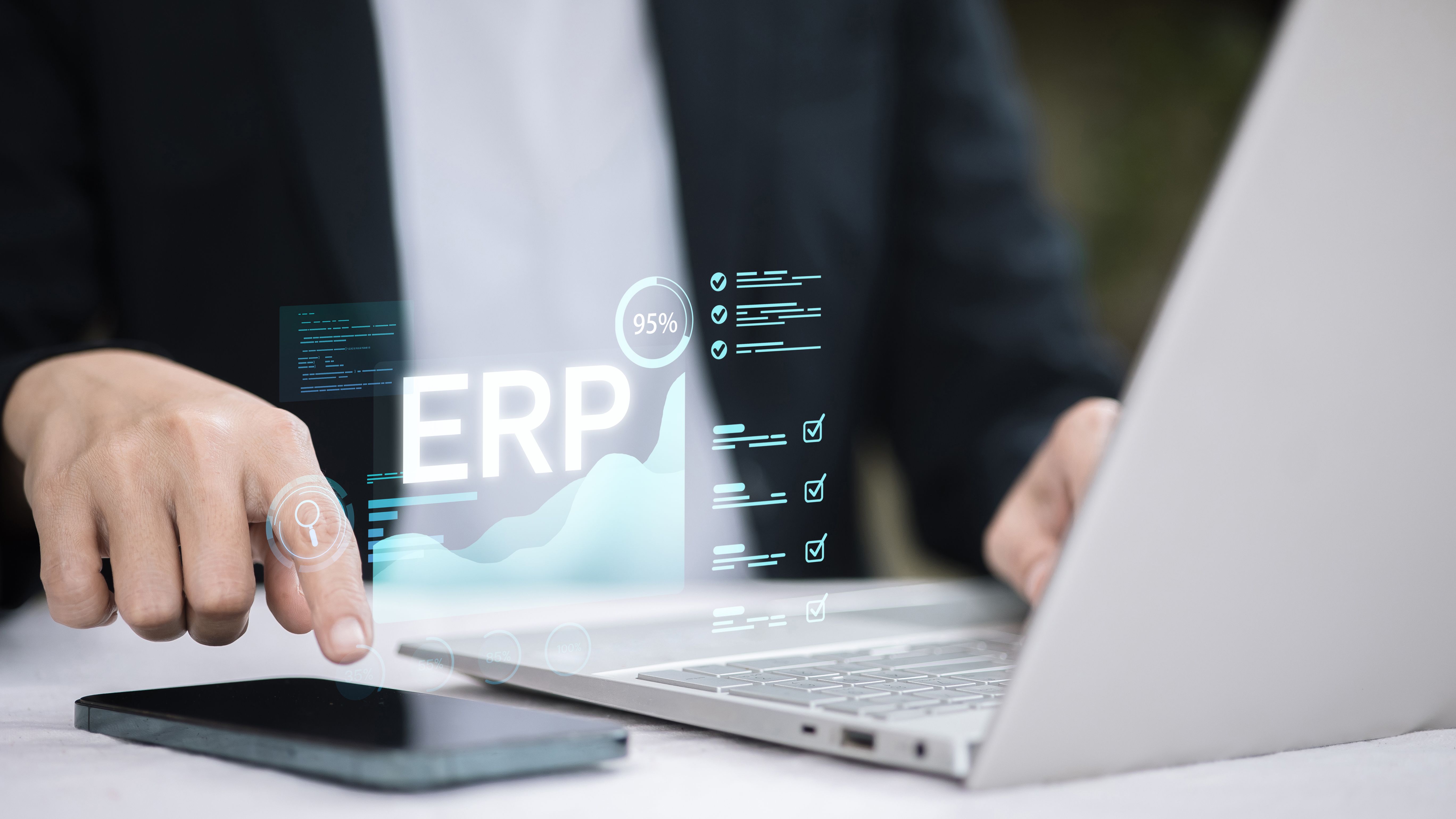 Businessman Using ERP System on Laptop and Smartphone