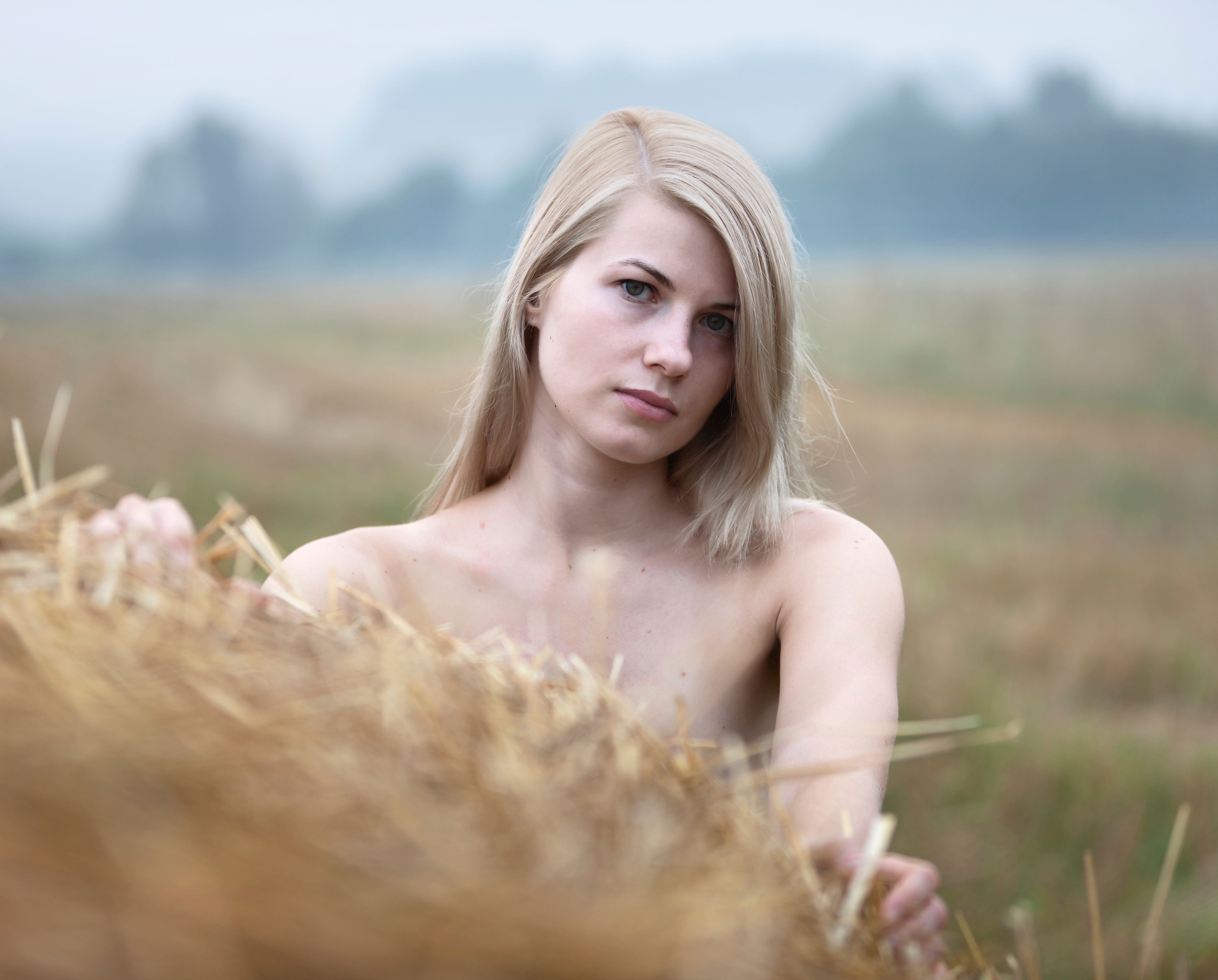 Young sexy woman among the straw.