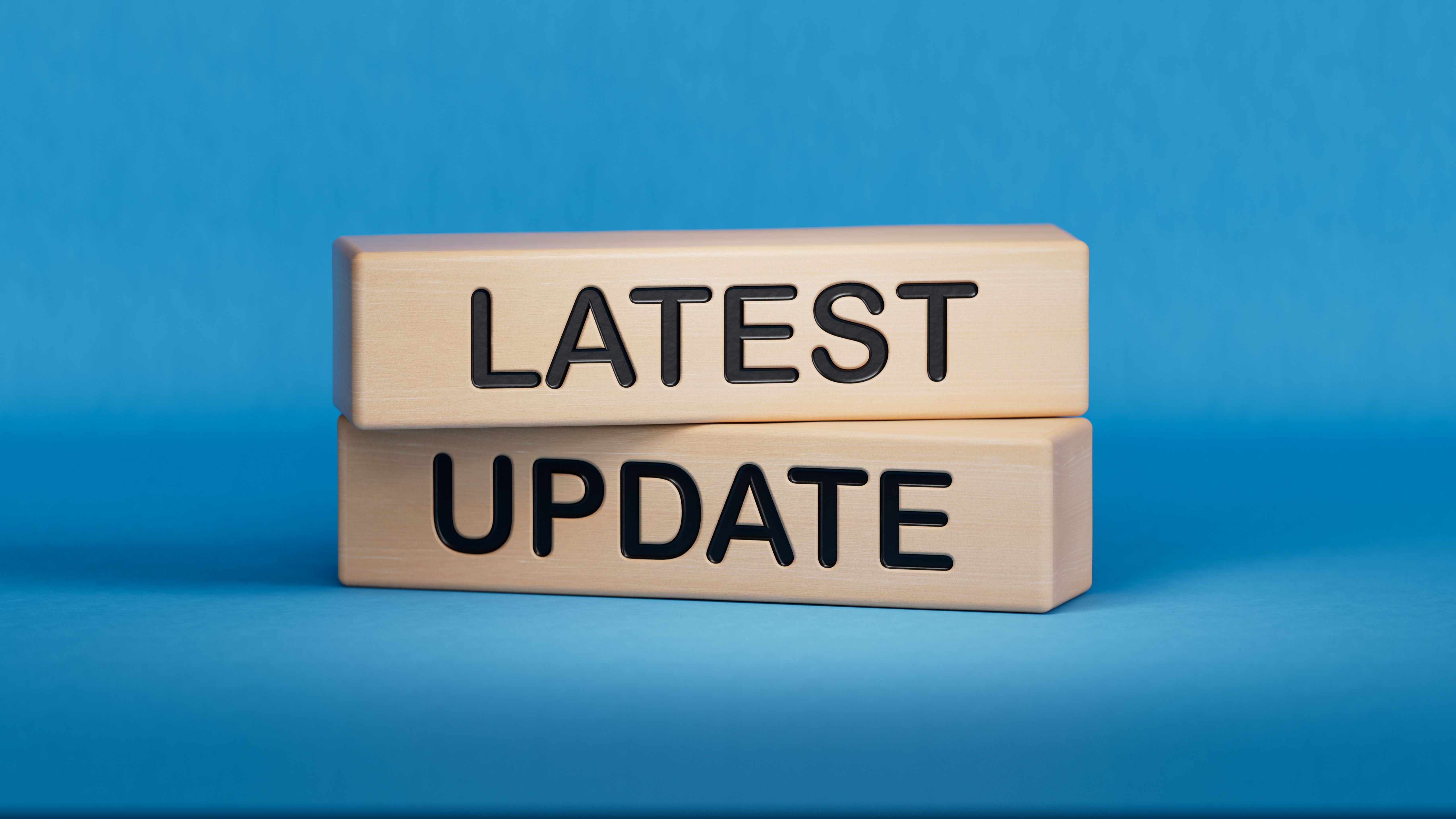 Latest update symbol. Stone wall with words Latest update.Business and Latest update concept. Copy space.3D rendering on blue background.