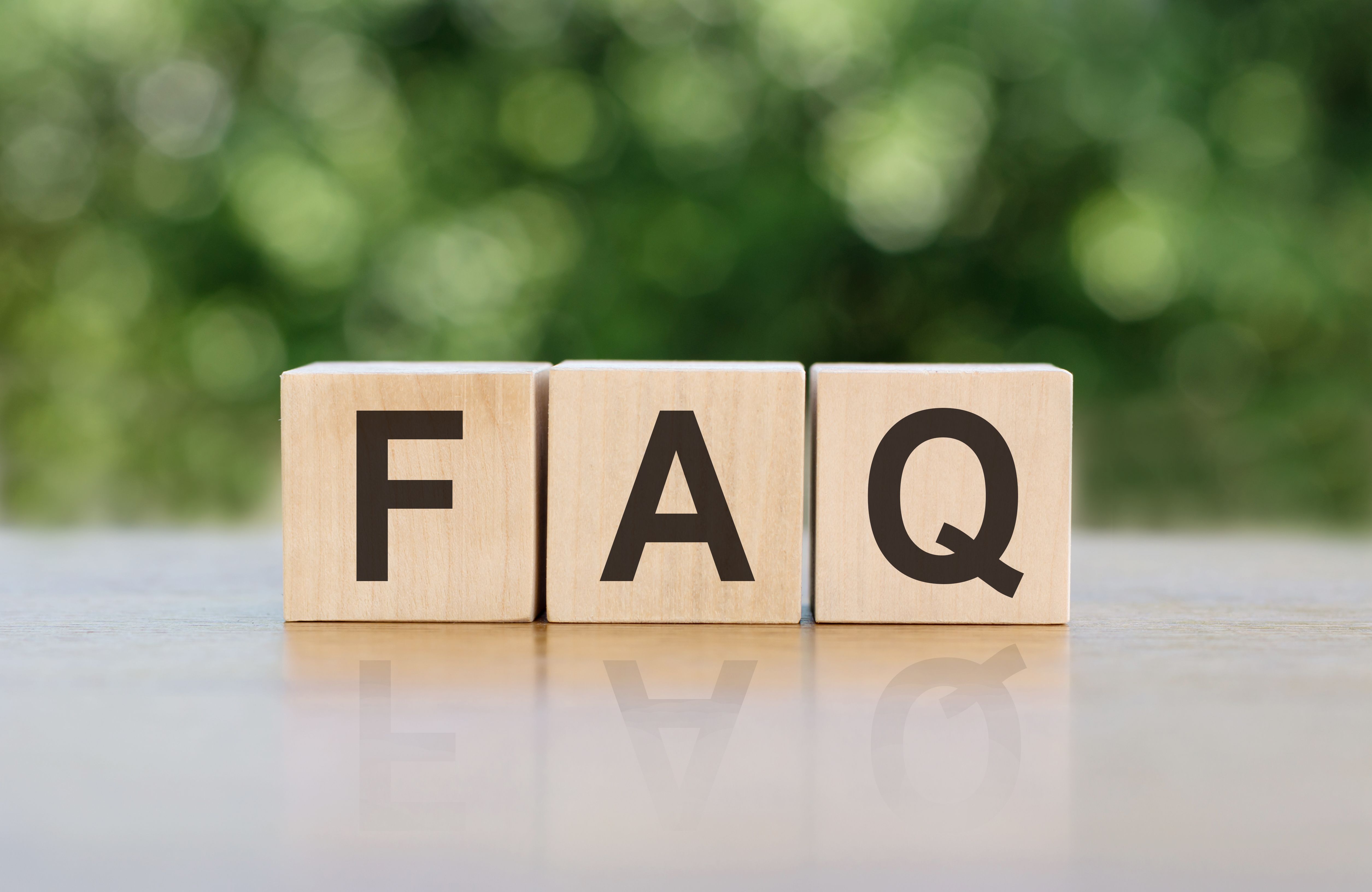 FAQ letter on block cubes on wooden table over blur green tree in park, Frequently asked questions, Business customer service and support concept FAQ letter on block cubes on wooden table over blur green tree in park, Frequently asked questions, Business customer service and support concept