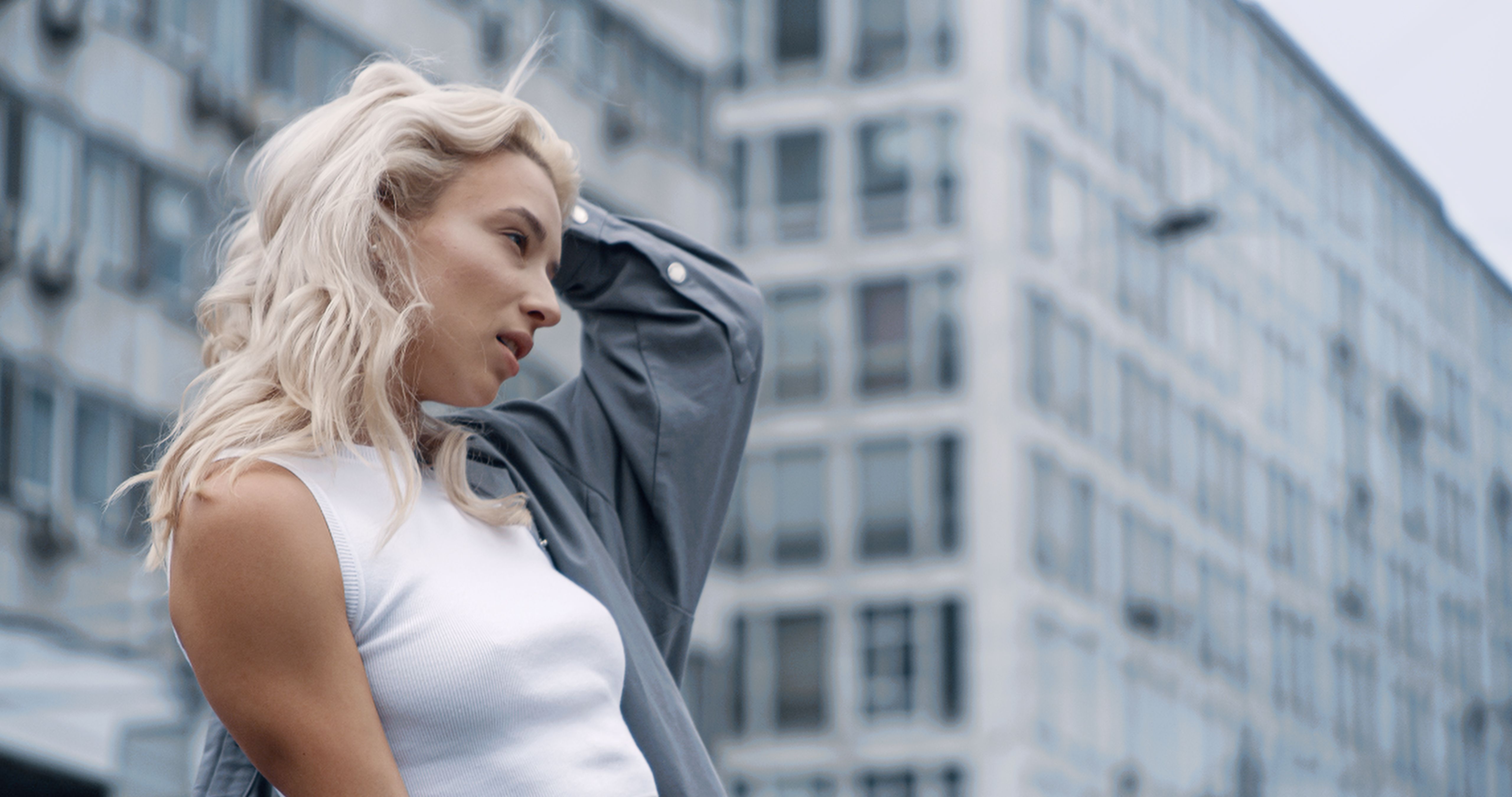 Sexy model posing downtown in urban city background at daytime. Sexy model posing downtown in urban city background at daytime.