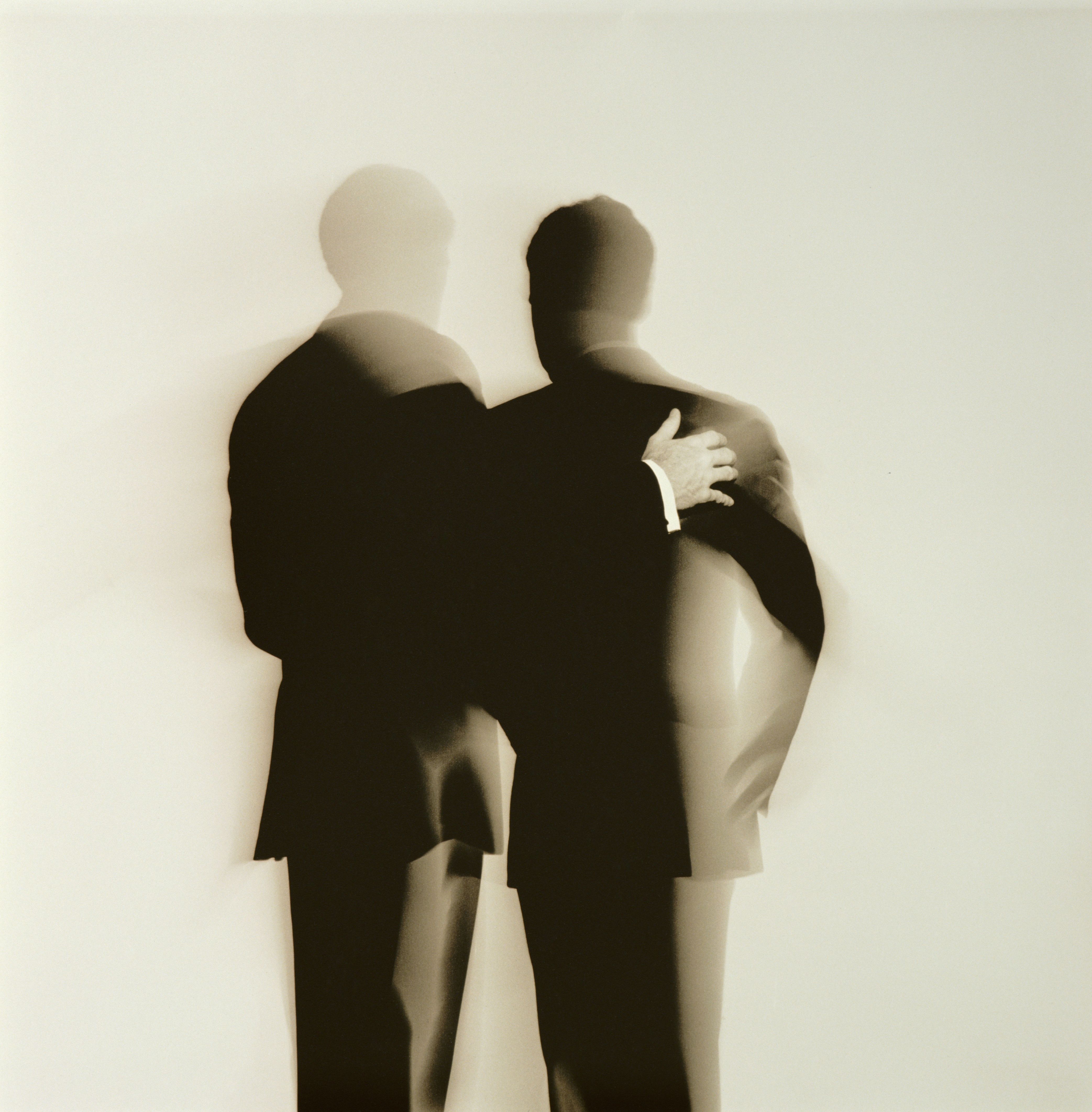 Abstract silhouette back view of two businessmen