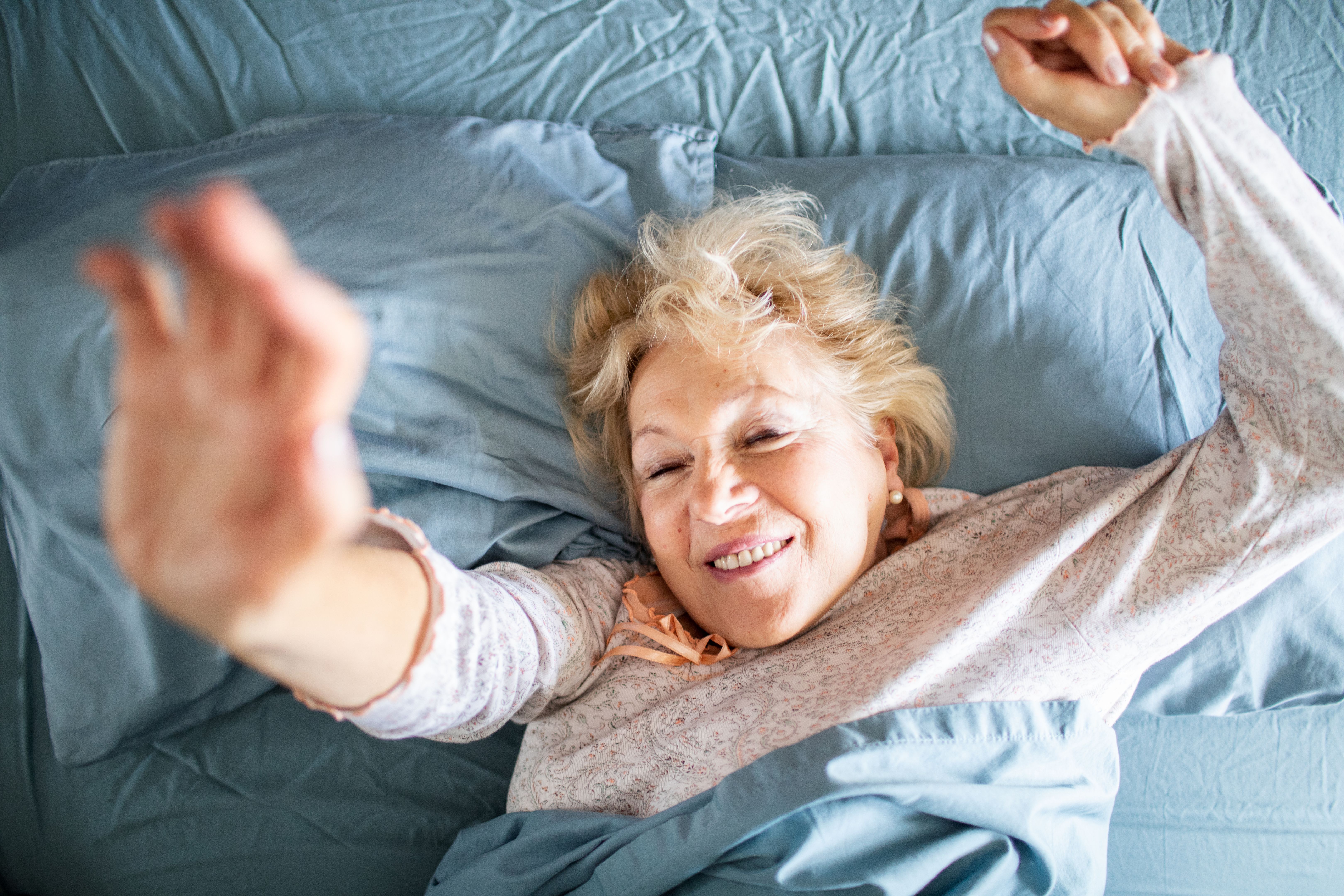 Smiling senior woman waking up in the morning Smiling senior woman waking up in the morning