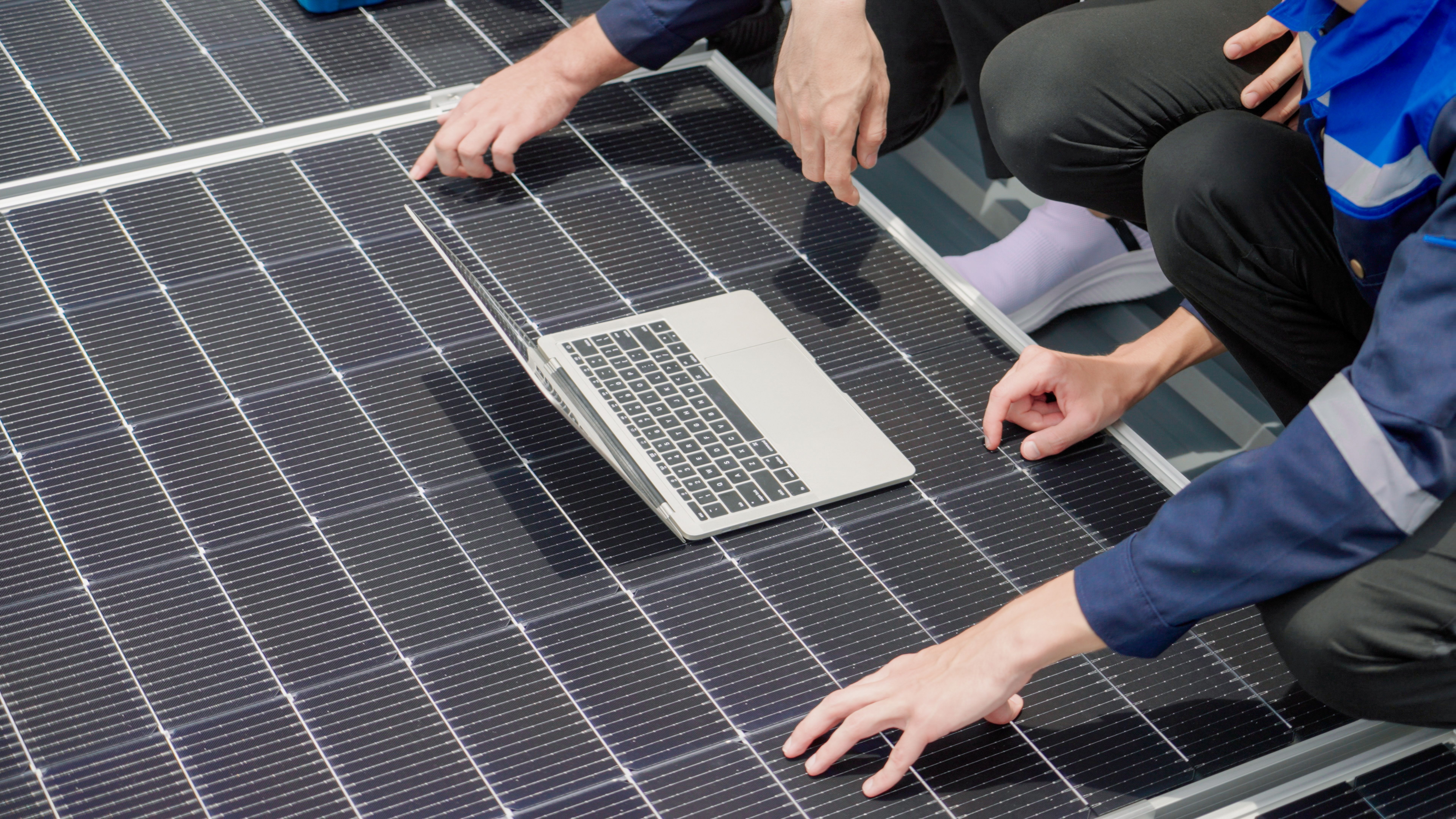 Engineer working on laptop at solar station Engineer working on laptop at solar station