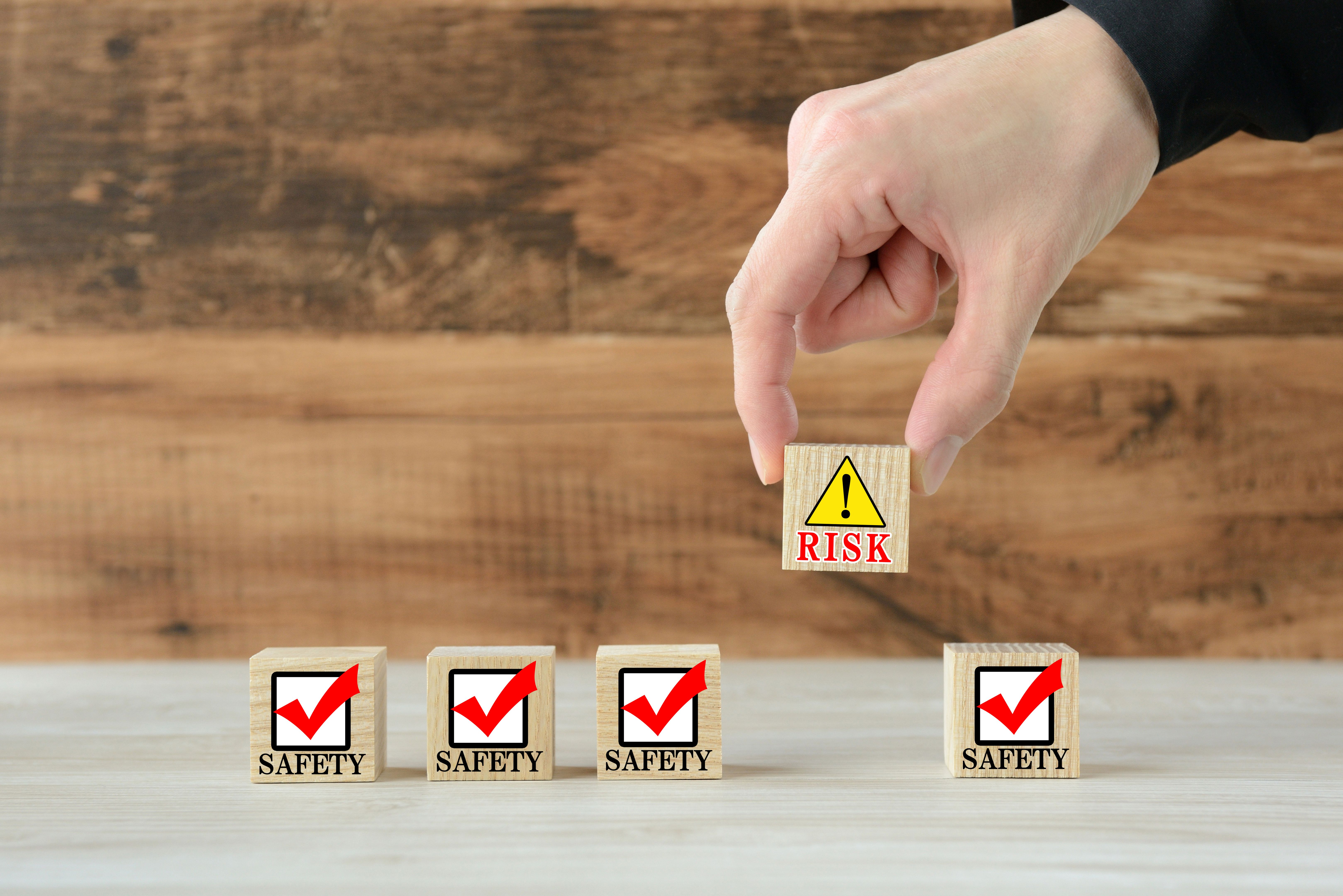 Human's hand getting rid of risk block