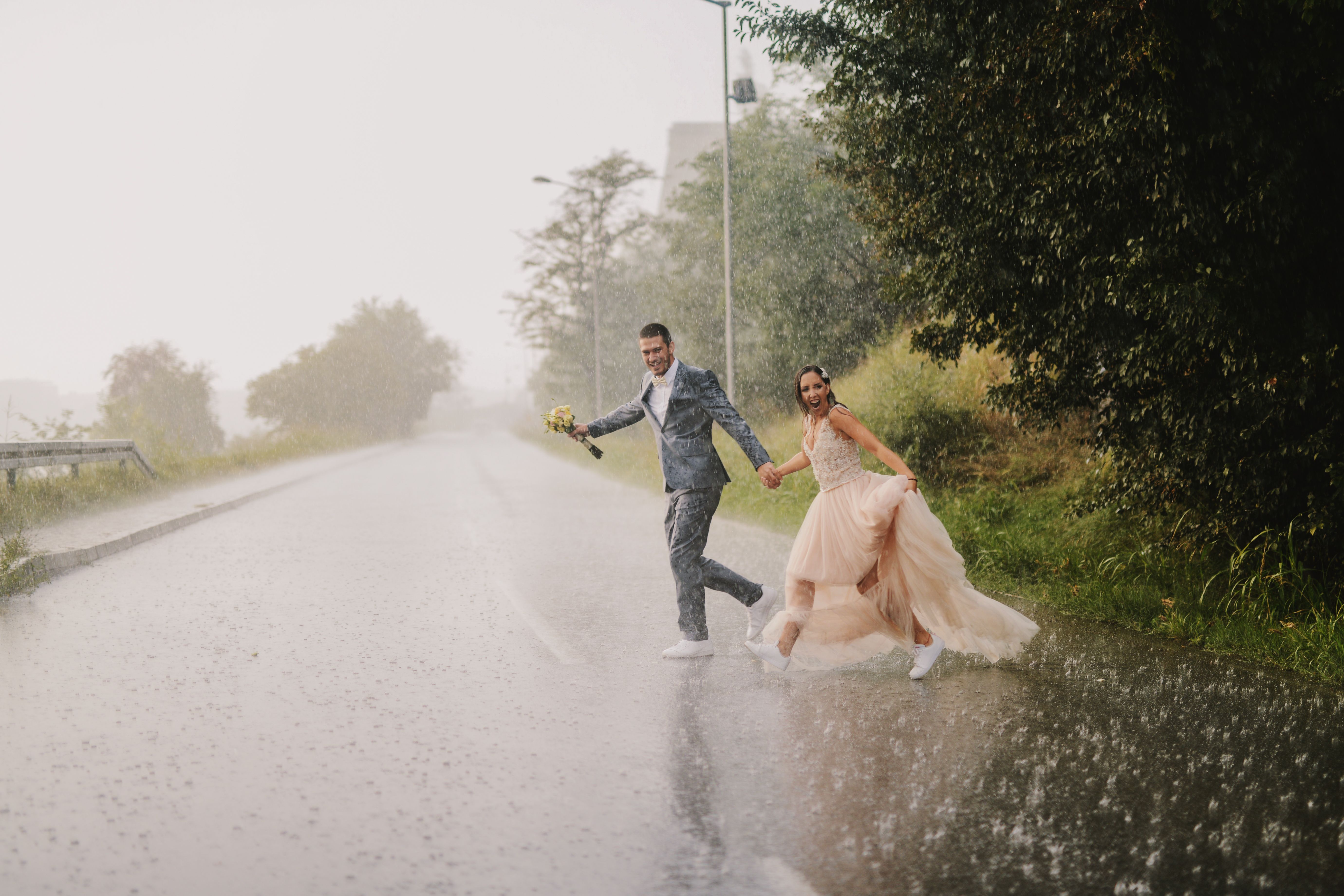 bride and groom rain